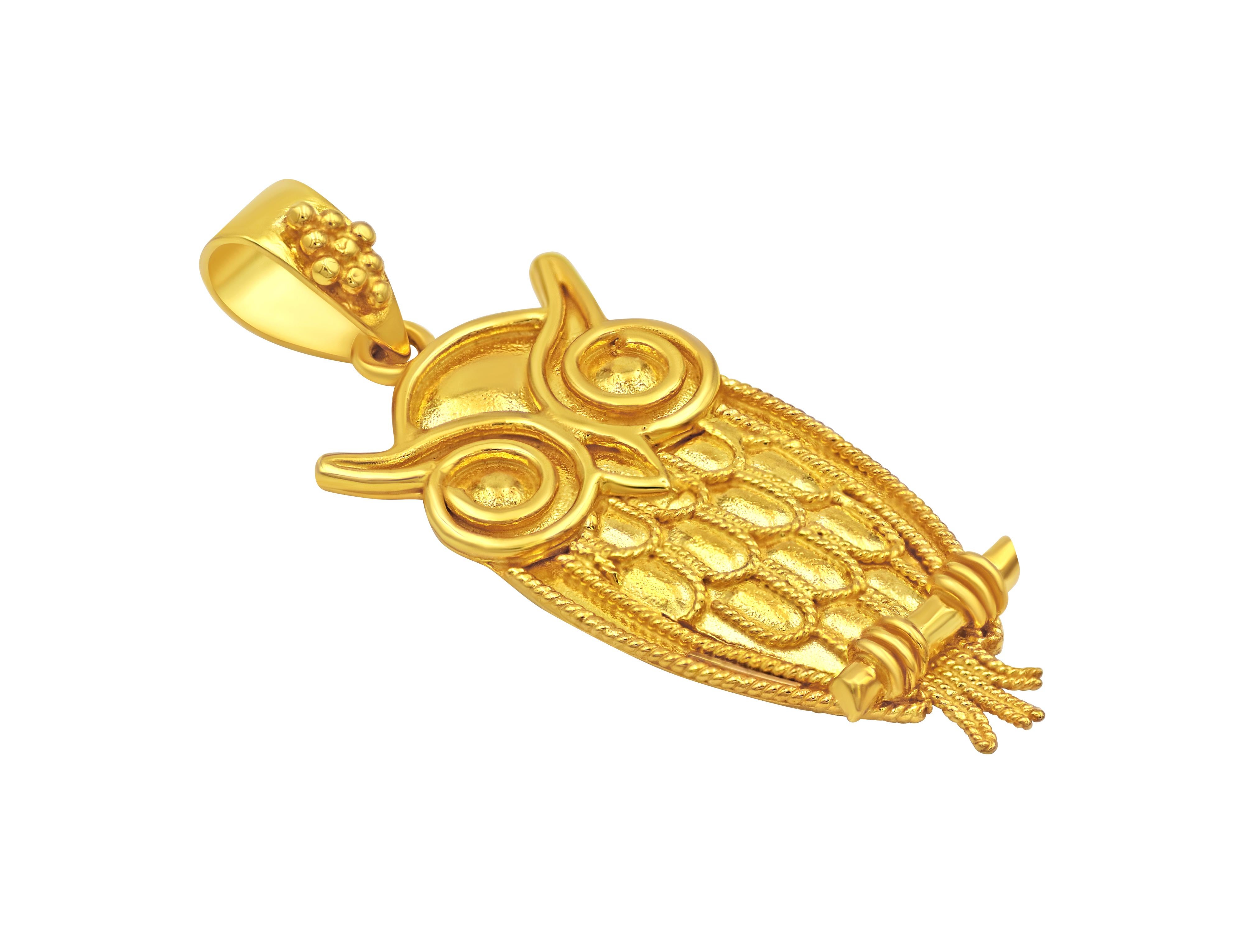 The owl pendant in 18 karat yellow gold handcrafted with filigree wires and decorated with granulation. 
Simple and very classy can be worn attached to anything and give it any level of formality you intend to. 
Symbol of Athens and wisdom was the