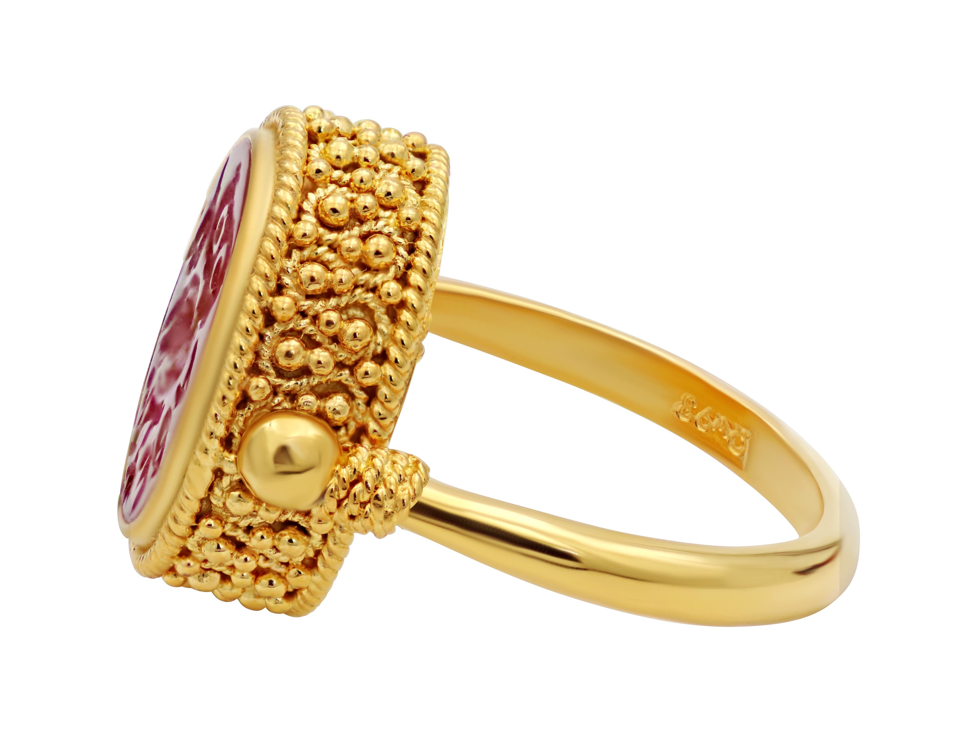 Reversible ring of 18k yellow gold and a natural cornelian made in museum replica and decorated with granulations and filigrees. The carnelian is hand carved showing the owl symbol of wisdom and symbol of Athens. The other side can be worn all gold