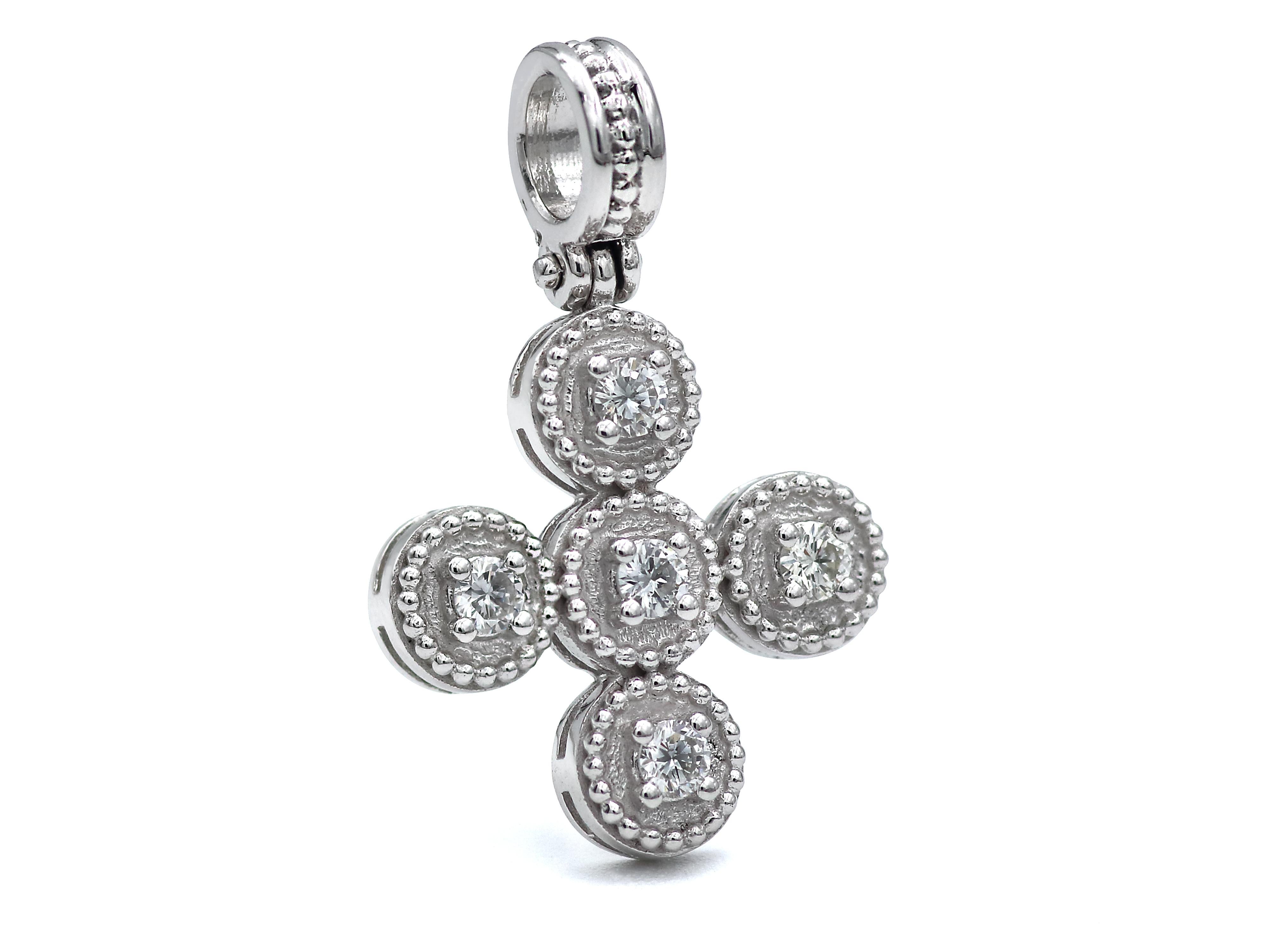 18k white gold cross of the balance collection with neoclassical inspiration work of granulations and a beautiful setting of four 0.35 carats not graded brilliant cut diamonds. A very tasteful piece with a strong thick bezel that will make you wear