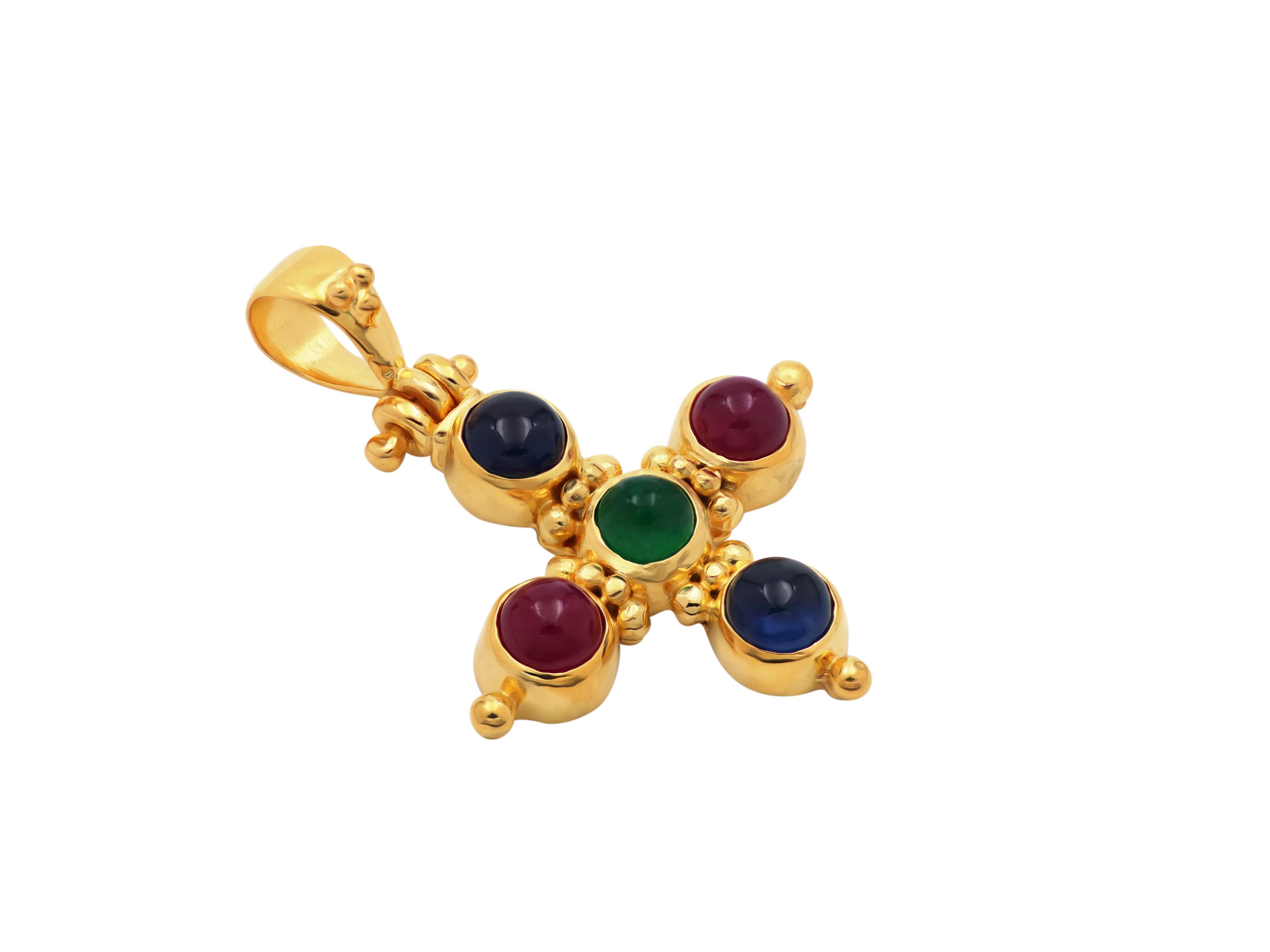 Classic cross completely handmade in the old traditional way in 18 karats gold set with round cut rubies, blue sapphires and emerald, decorated with granulation.