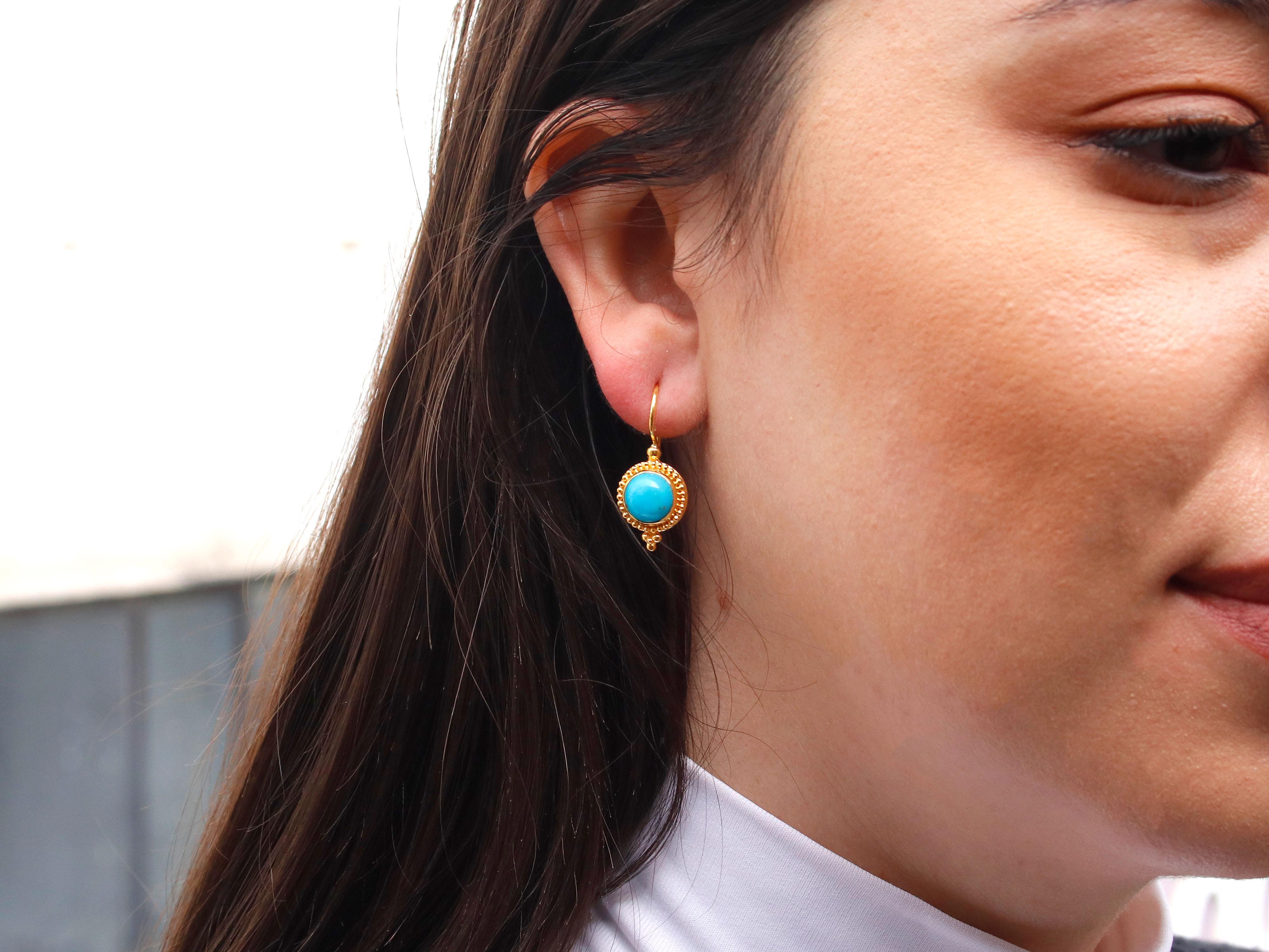 Earrings crafted from 18-karat yellow gold adorned with turquoise and intricate granulation details offer a captivating blend of elegance and artistry. The warmth of the yellow gold beautifully complements the serene hues of turquoise, creating a