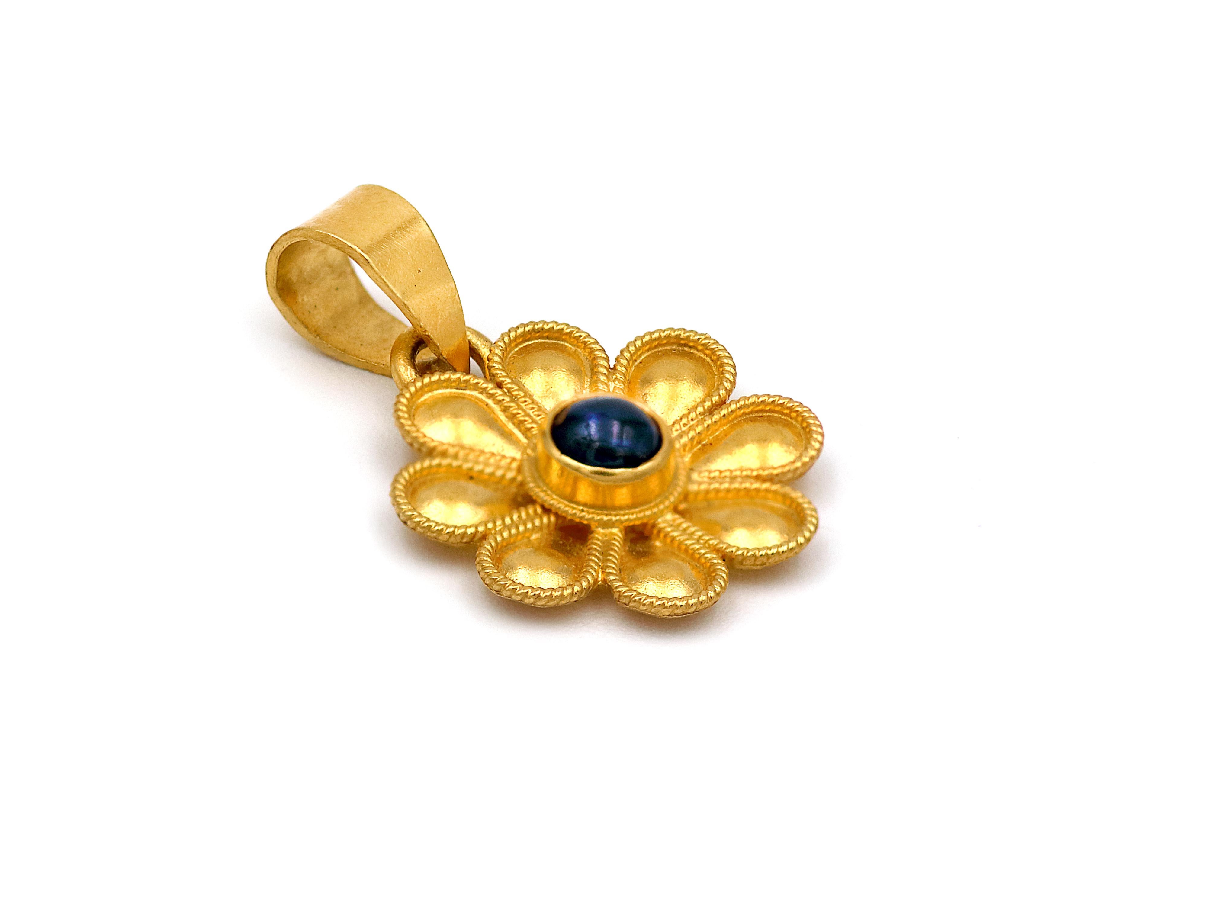The daisy pendant in its sweetest version set in 22k yellow gold. A museum legend that it’s been so presented in our history here in a simple single leaf and set with Lapis Lazuli that creates a beautiful color difference. A super daily symbol of