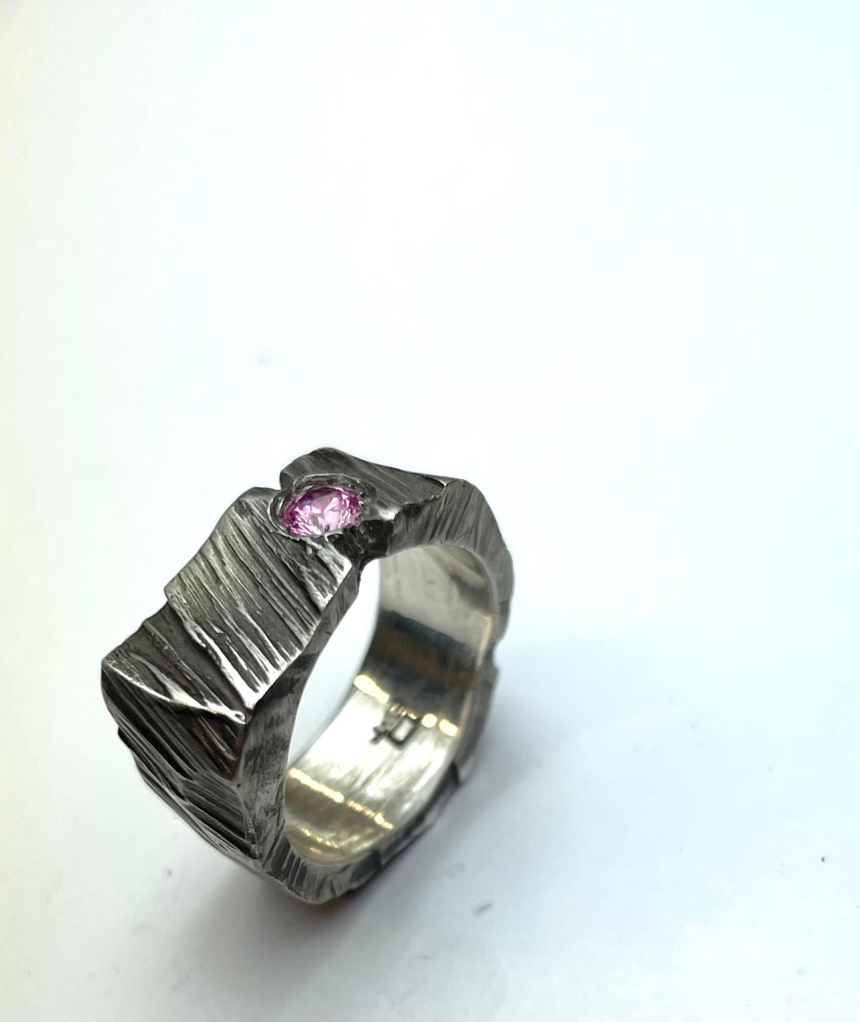 A Crack as a rock ring
This ring is inspired by tree bark… it’s as if the ring of bark was cracked and it is being held together by a stone.
This is a unique piece, One of One.
Hand carved by the artist.
size #6.5
sterling silver: polished and