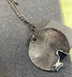 Dina González Mascaró "melted medal" pendant necklace oxidized sterling silver