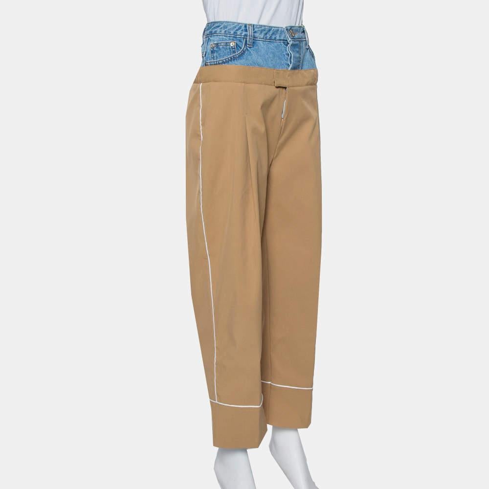 These Dina Zaki pants are simply amazing. Featuring a faux layering of denim, these pants come with pockets, button fastenings, and an elegant beige hue. Team it up with a feminine top and sneakers. 