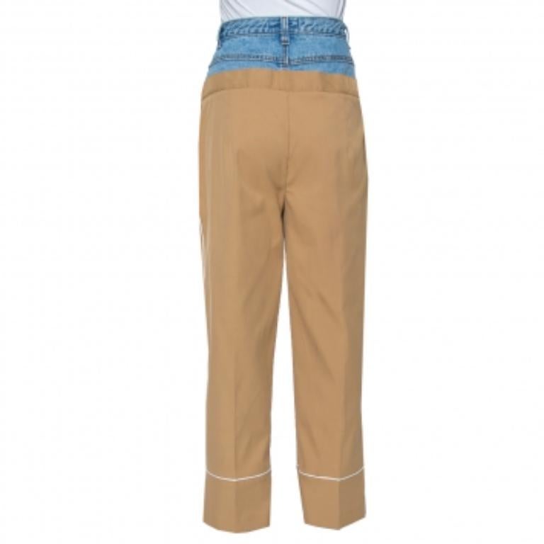 These Dina Zaki pants are simply amazing. Featuring a faux layering of denim, these pants come with pockets, button fastenings, and an elegant beige hue. Team it up with a feminine top and sneakers.