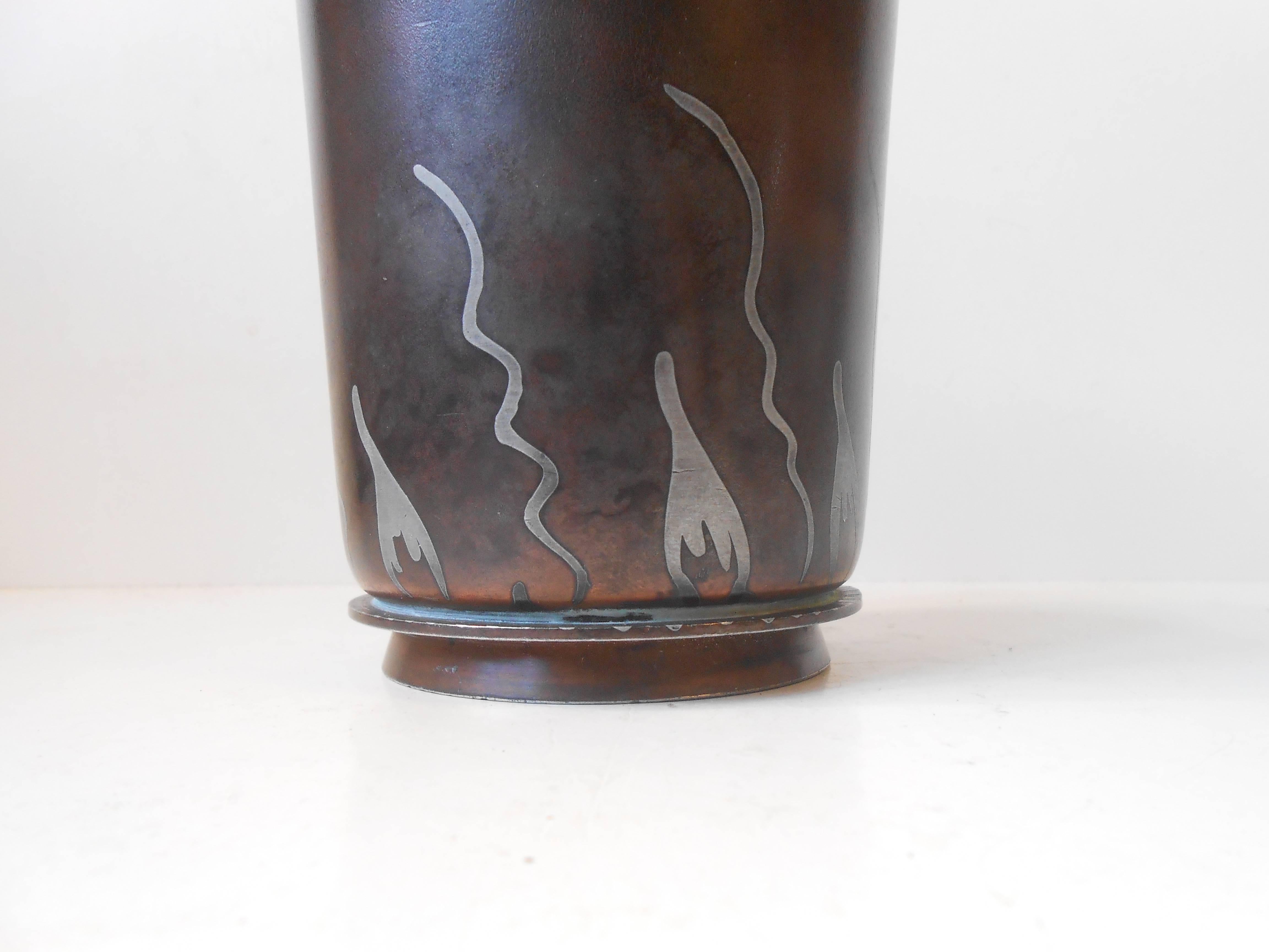 Metallurgy is the scientific experimentation of recovery, refining properties and uses of metals and formulation of metal alloys. Bronze, copper, tin, brass and silver are the most common ingredients. This vase made by Groos and Christensen in 1921