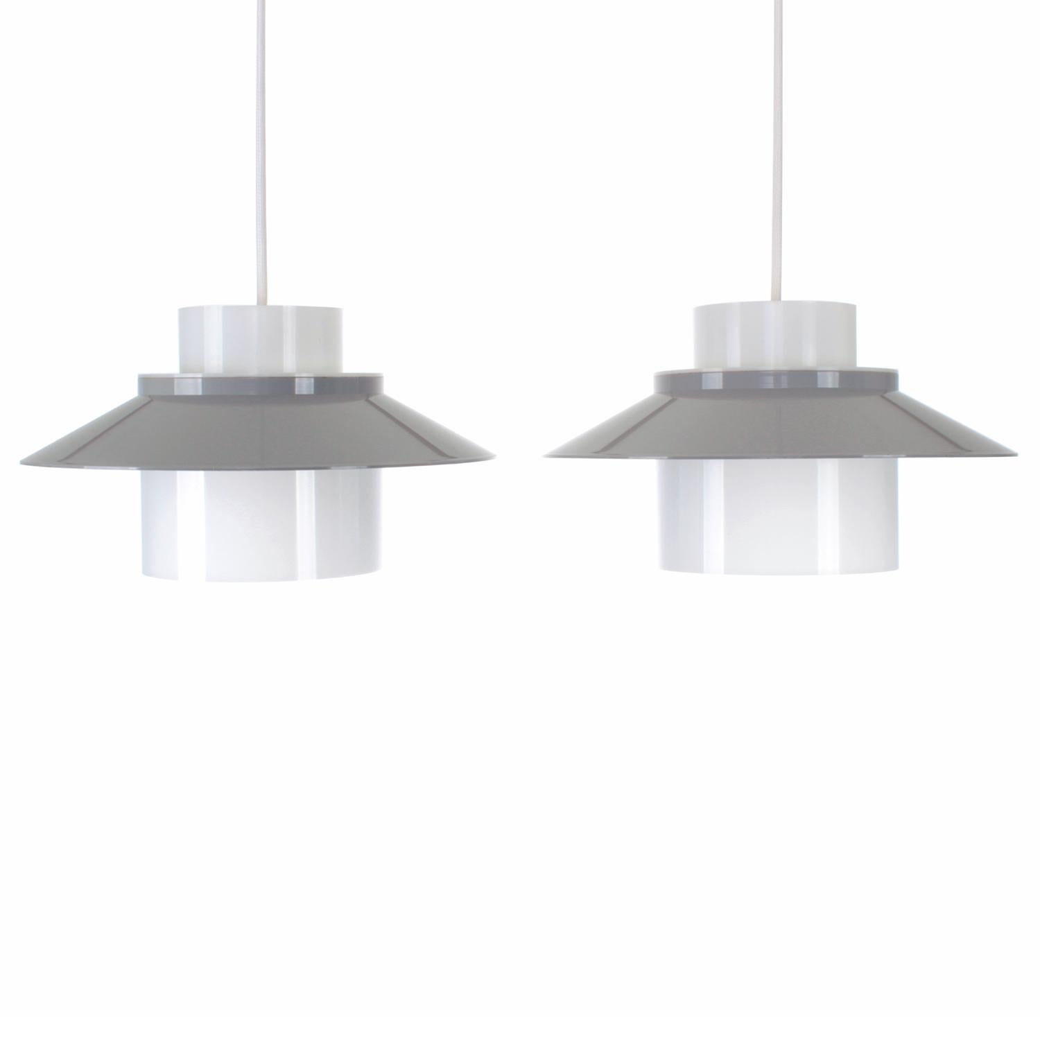 Dinette- pair of ceiling lights by Bent Karlby in 1970 and produced by Lyfa - Danish Modern lighting - gray and white acrylic lights in good vintage condition.

Pair of cute pendants cast in acrylic plastic with a white (translucent) inner core