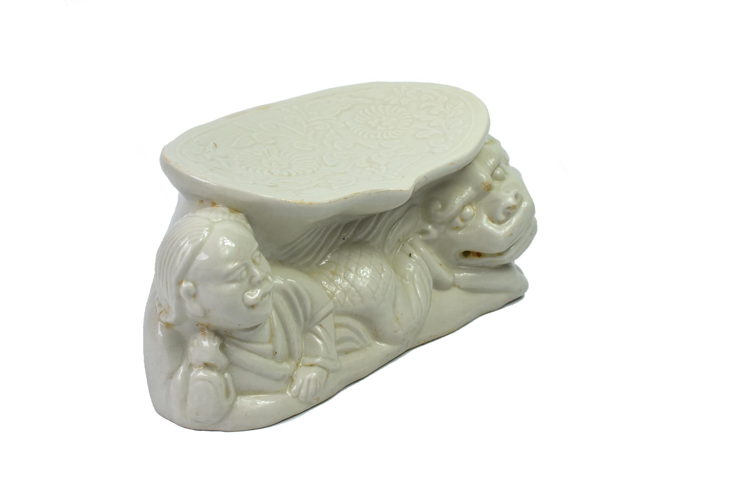 A Song dynasty style porcelain pillow of the Ding kiln. The Ding kiln is one of the most important Song dynasty kilns. It produces milky white or beige glazed pieces that are favored for their simplicity and country grace. Featured is a man and a