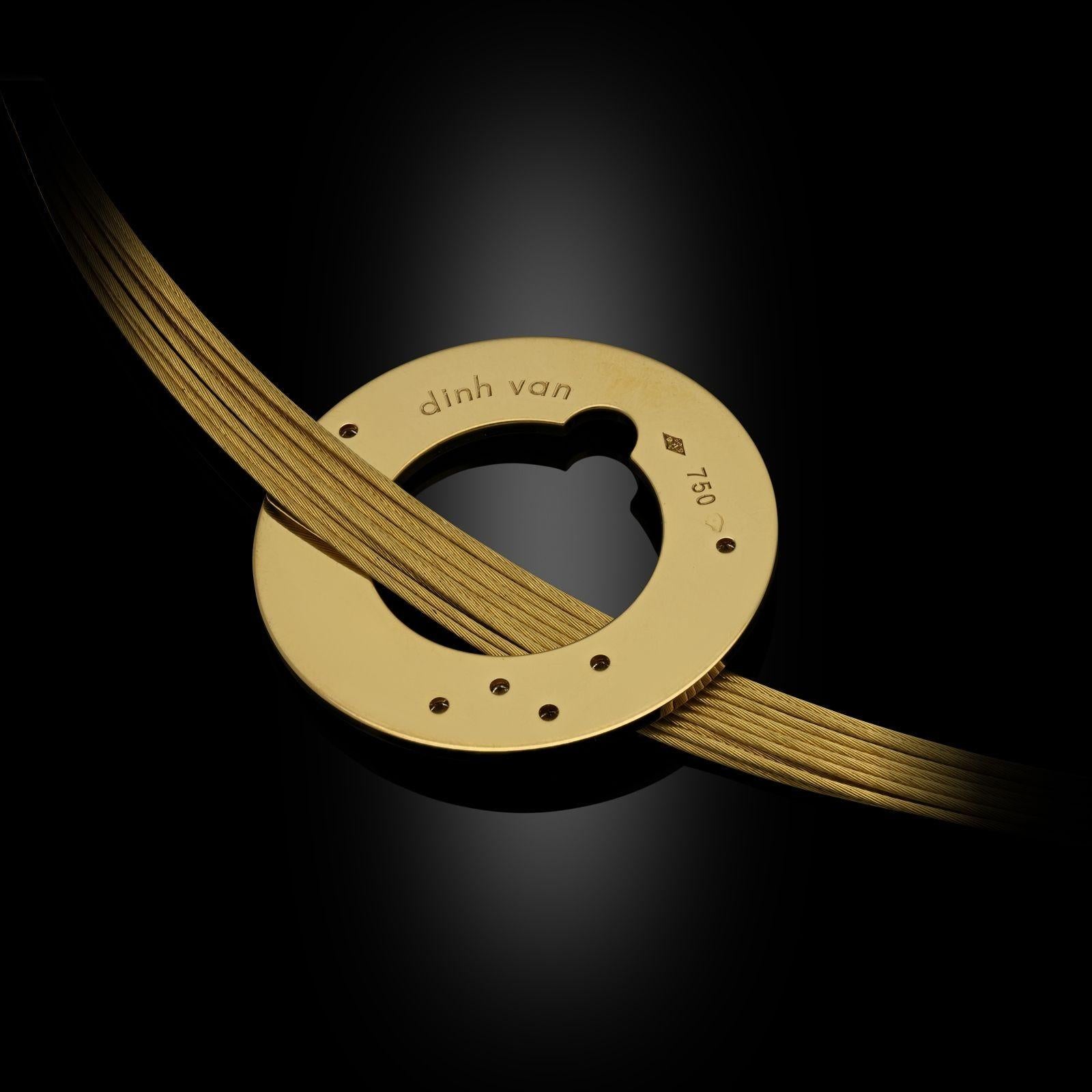 A 18ct gold choker necklace by Jean Dinh Van, c.2000s, the necklace formed of ten individual twisted gold wire threads that sit around the base of the neck, threaded through with an 18ct gold disc with open centre, decorated with a scattering of
