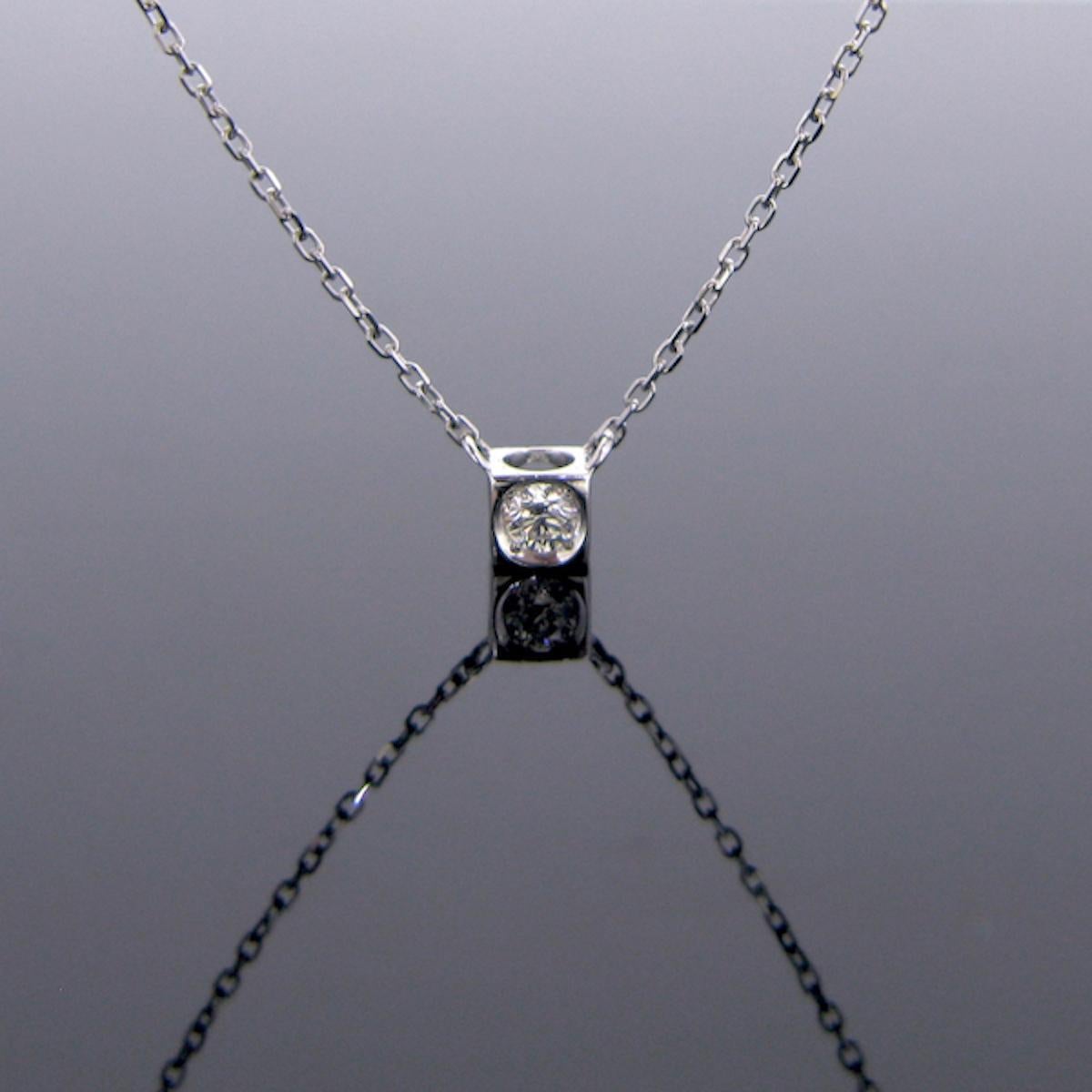 A refined Diamond pendant necklace by DINH VAN. This lovely pendant is set with a brilliant cut diamond weighing around 0.15ct. It is closed set on an airy cube.It is perfect to wear every day. It was made by the French jewelry brand DINH VAN. The