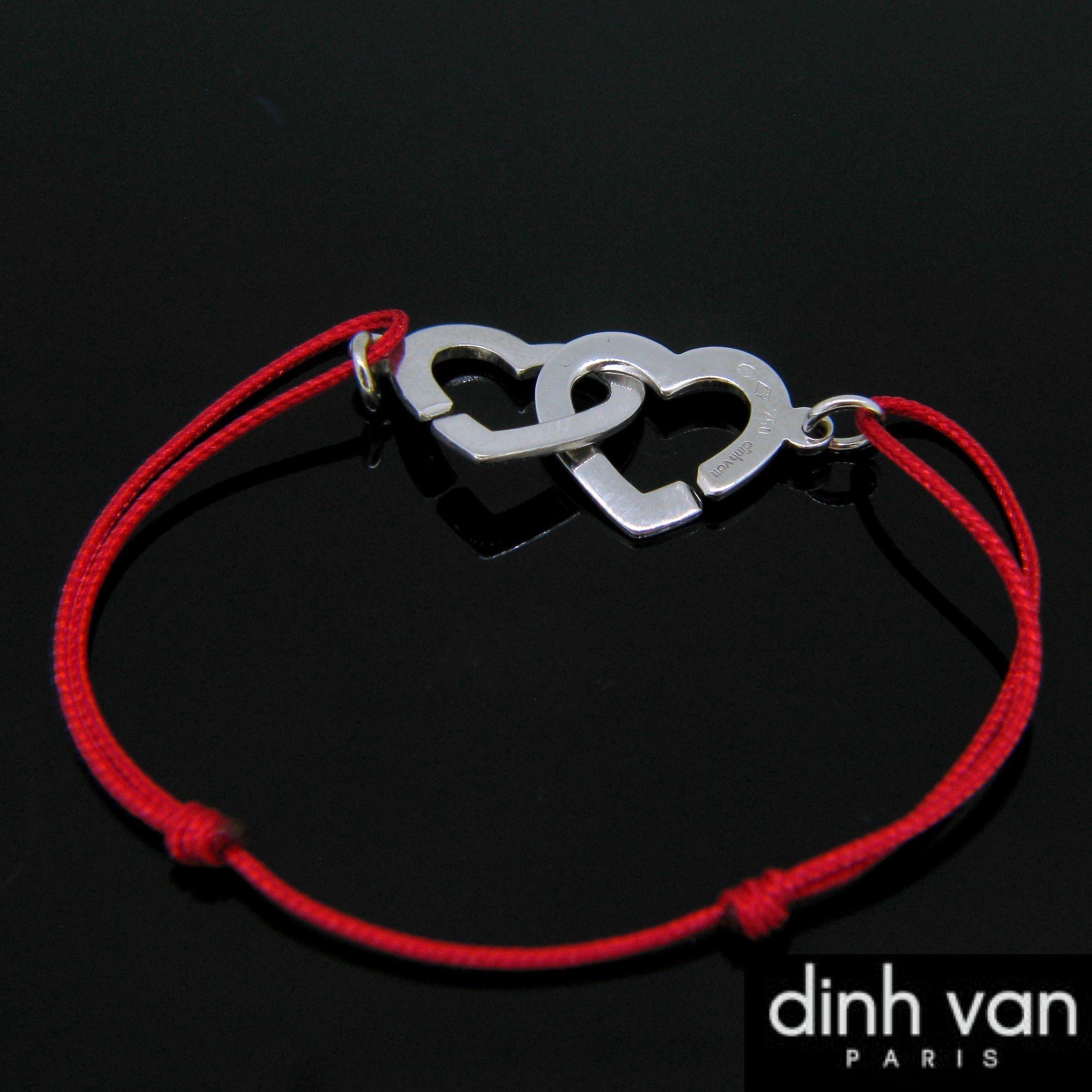 This charming bracelet is from the iconic Dinh Van collection The Menottes. They are shaped as two hearts, to symbolise the bonds of love and friendship. The rope has been replaced and is brand new and the hearts have been polished. It is in