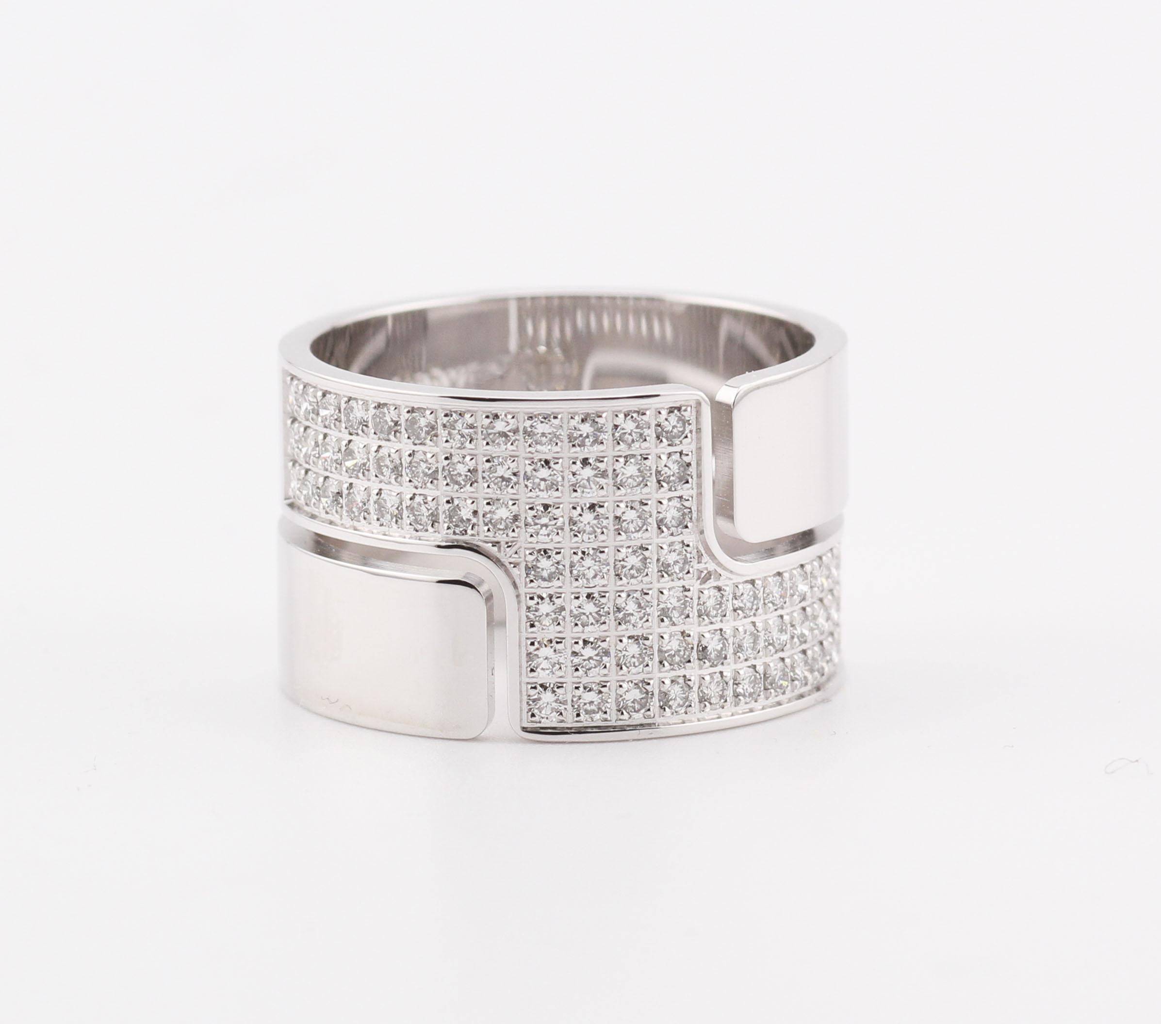 The exquisite ring is a testament to refined luxury and meticulous craftsmanship. Crafted from premium white gold, it exudes a modern and sophisticated charm. The ring's design features a bold, wide band that is both striking and elegant.

Adorning