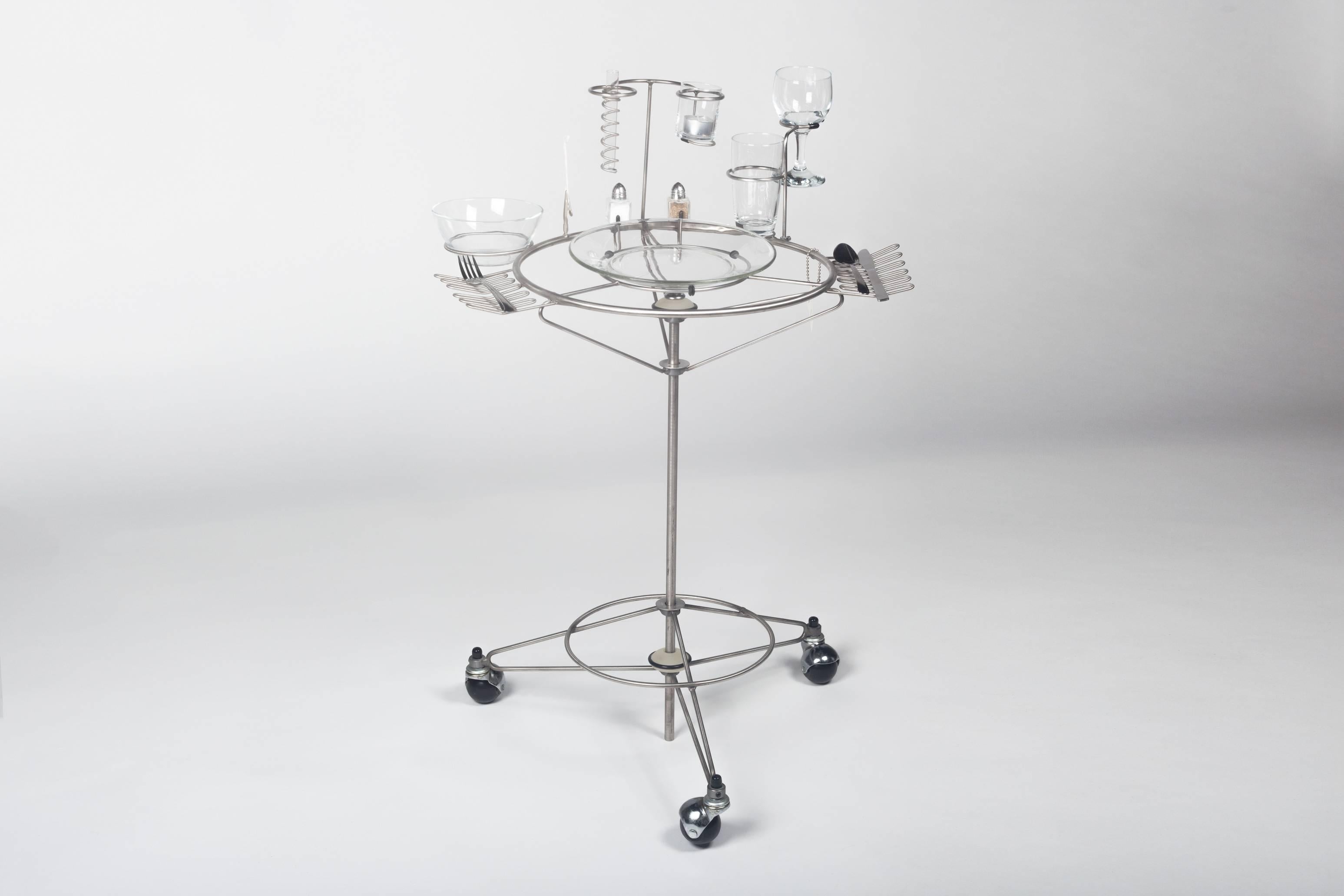 Virtual Diner dining cart by Joey Manic, 1990s. Metal wire structure on rolling casters. Original water and wine glass, flower vase, candle holder, bowl, plate, salt & pepper shakers, toothpick and flatware. Made in Northeastern United States and
