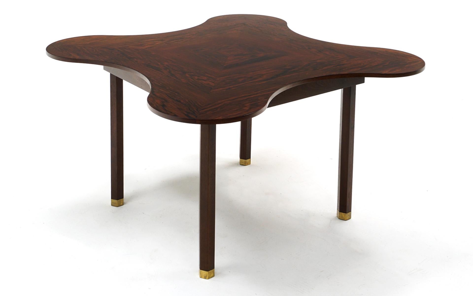 Rare Brazilian rosewood dining / center / game / kitchen table on hexagonal legs with brass feet designed by Edward Wormley for Dunbar circa 1950s. Unique organic clover-like shape. This has been expertly restored and refinished. The grain patterns