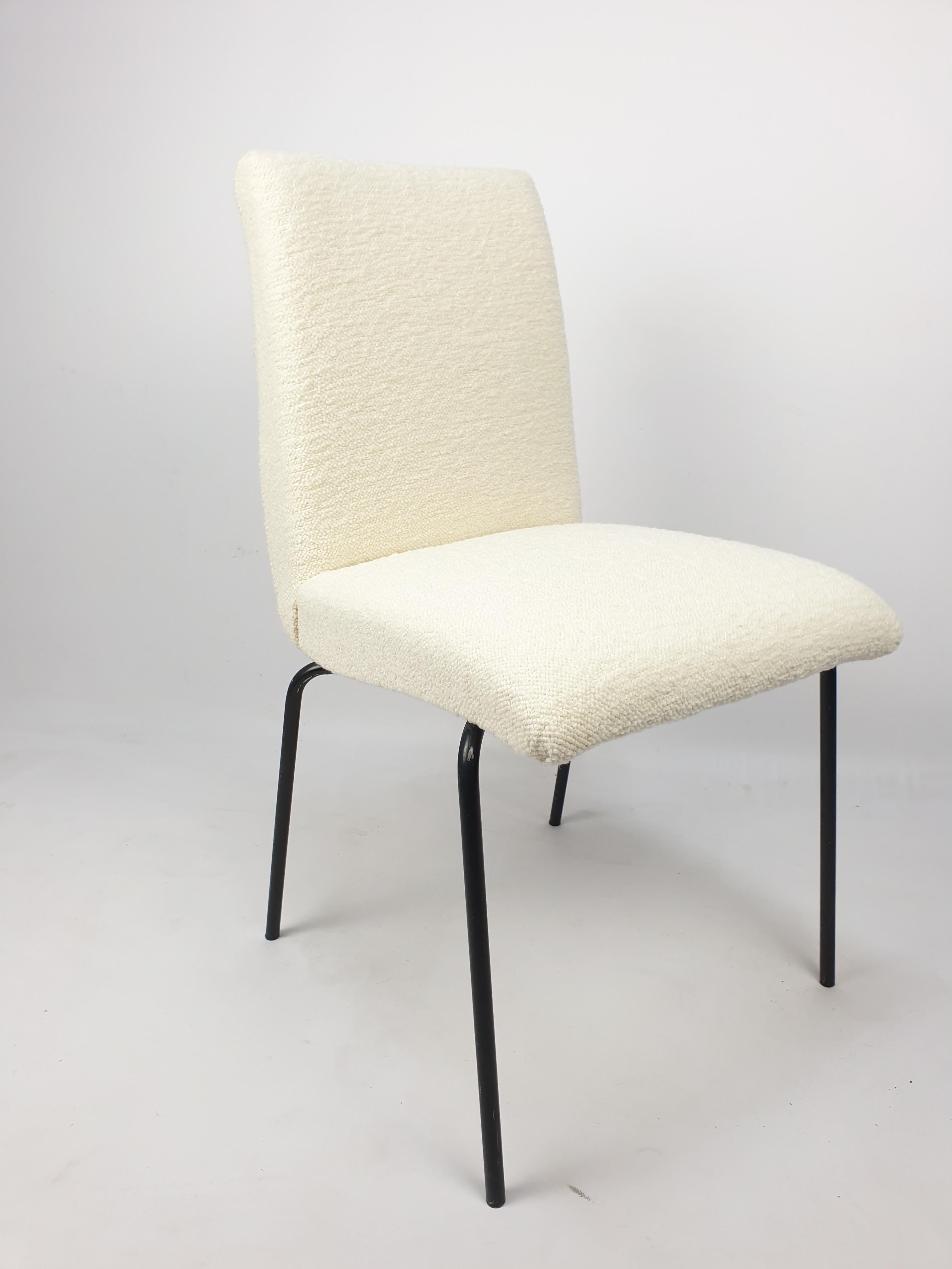 This mid-century dining chairs were designed by Pierre Guariche for Meurop in Belgium, circa the 1960's. They feature black tubular metal frame. The chairs are restored with new lovely Dedar bouclé fabric.