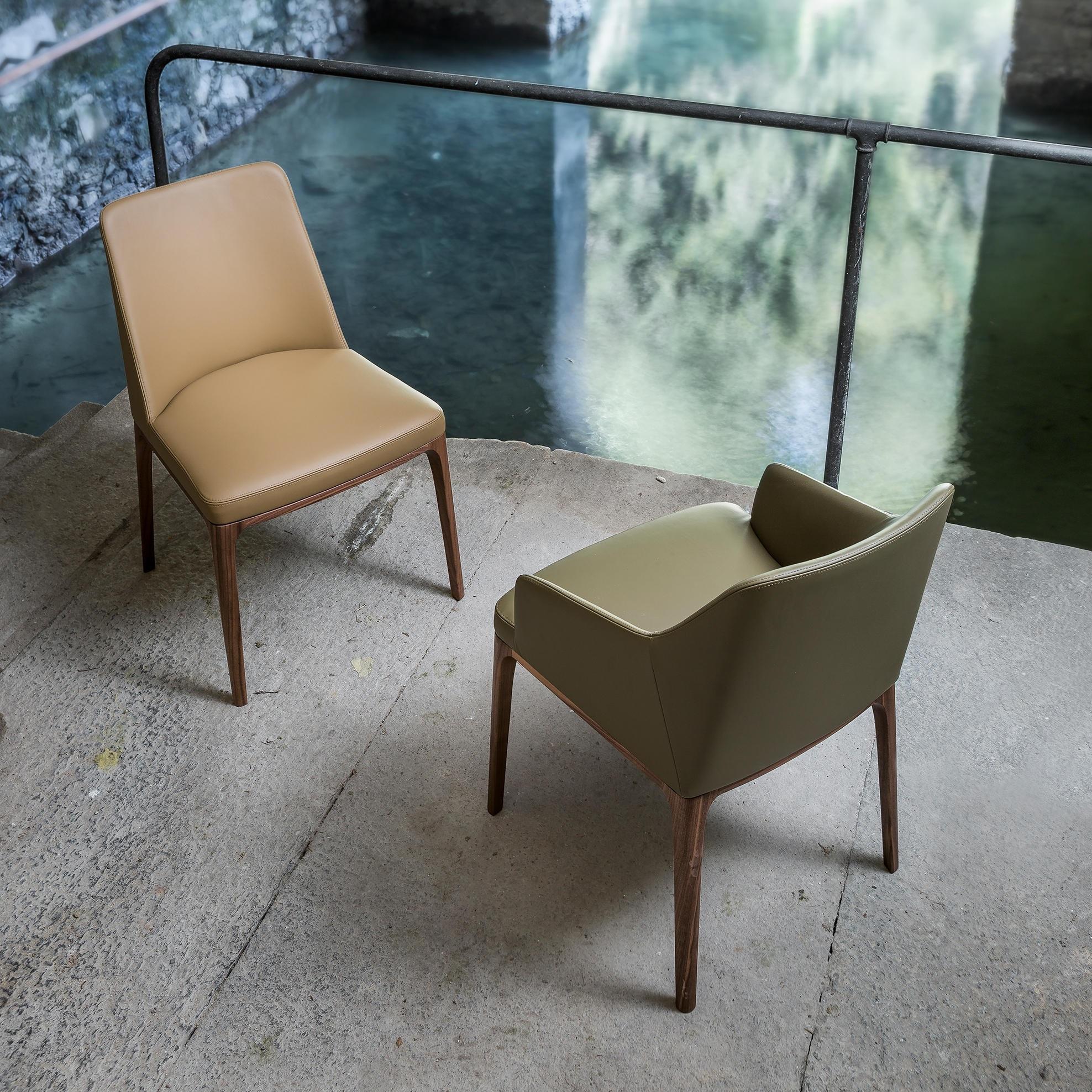 Modern Dining Chair Featuring Solid Wood Legs and Upholstered in Leather For Sale