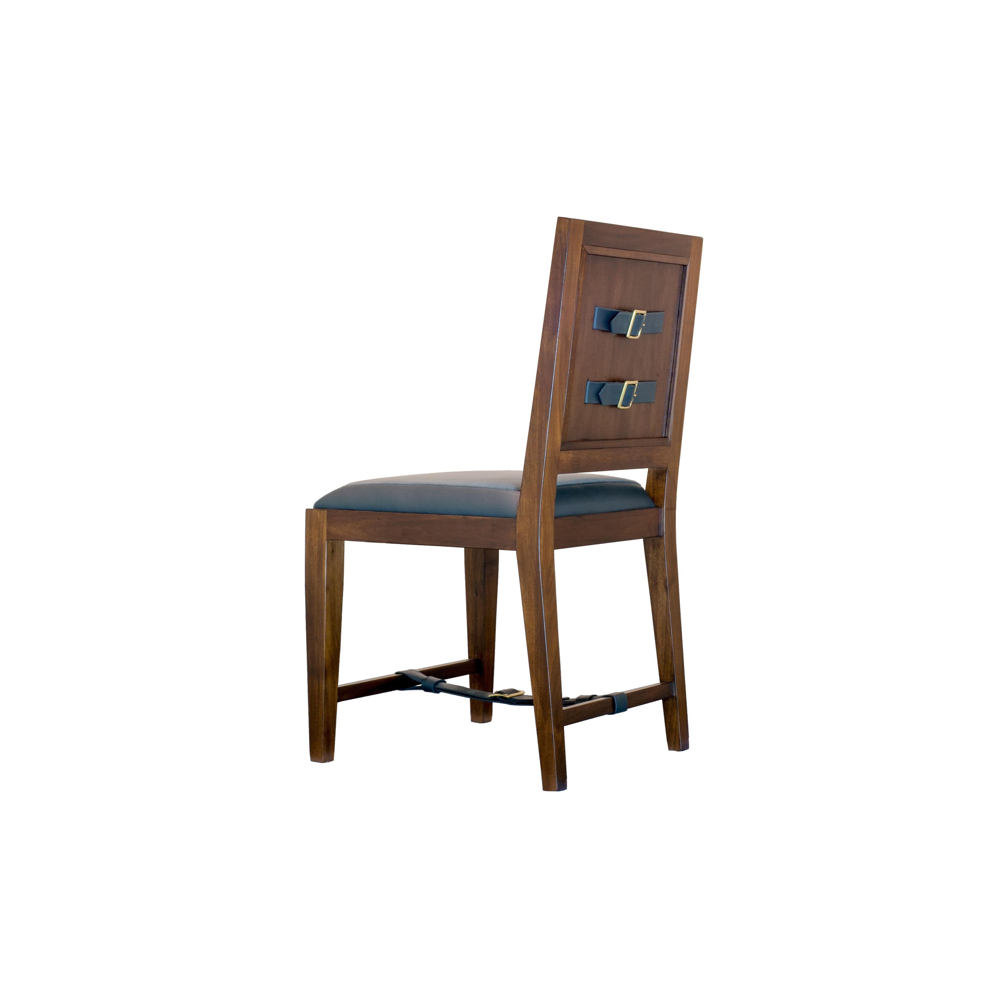 The solid walnut classic French dining and desk chair is handcrafted with traditional joinery. The upholstery features a combination of leather and fabric and is an homage to 1940s French designer Jacques Adnet. Custom sizes and finishes available.