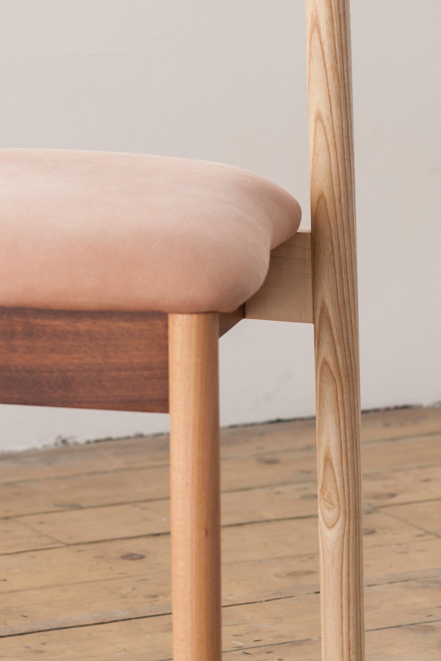 'One of a kind' dining chair, upholstered in salmon pink suede.
Handmade.

Materials: 
Ash, walnut, sycamore, beech, oak, maple, iroko, suede.

Dimensions: 
43 cm x 146 cm x 77 cm 
17’’ x 18’’ x 30’’.