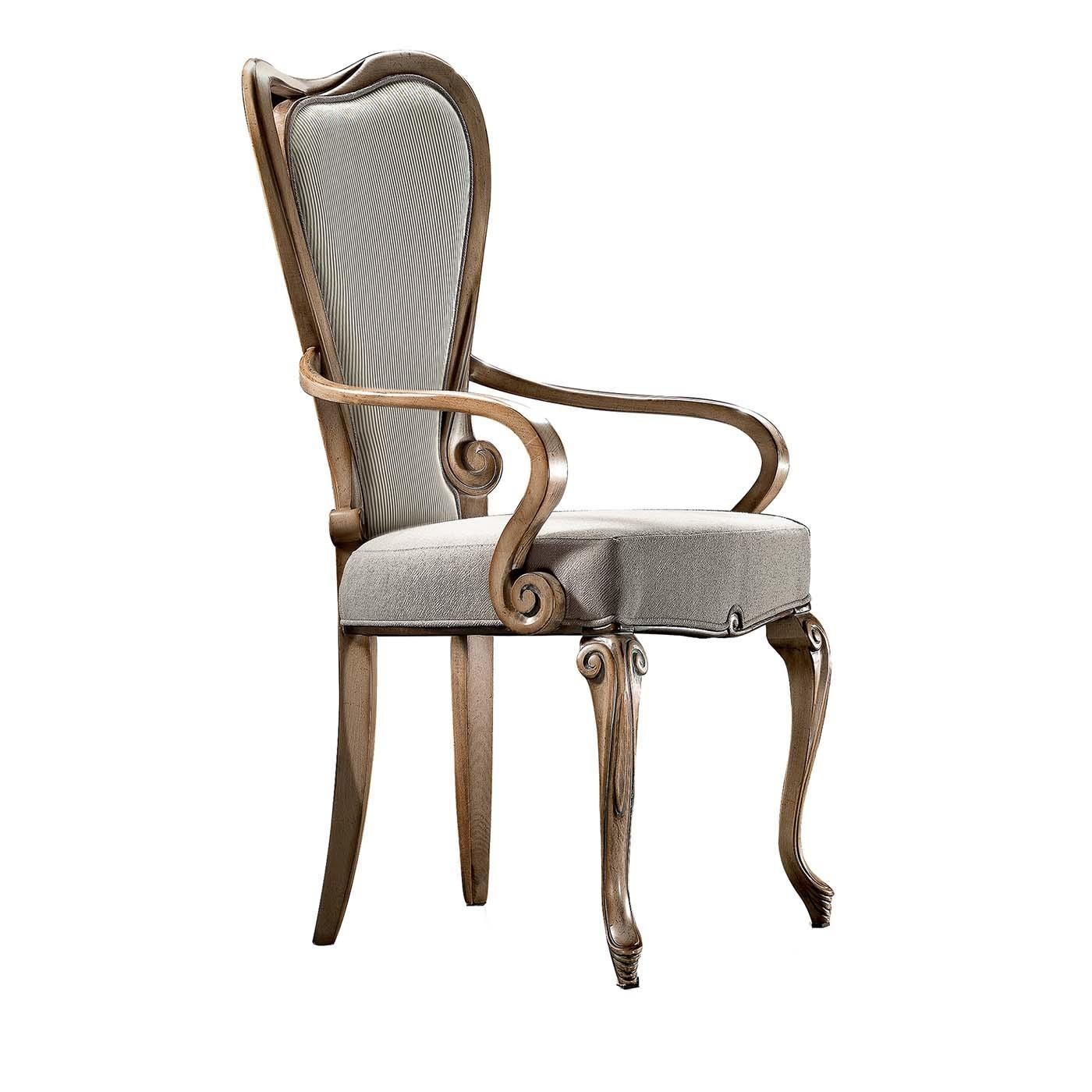 Dining chair with armrests in a rounded and harmonic design, finely crafted and finished in every small detail. A Fine example of a Baroque style dining chair with armrests and wooden frame that beautifully encircles the back, providing the elegant