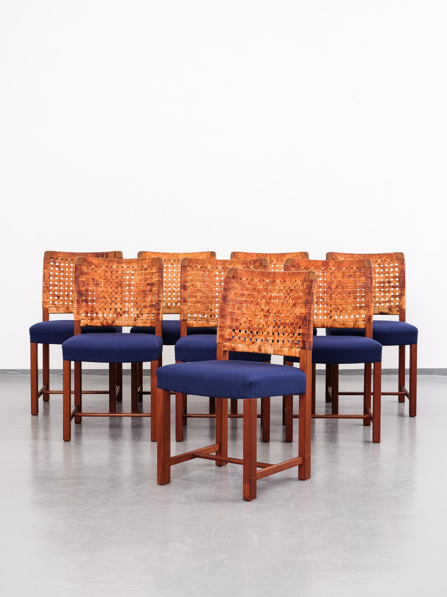 Set of eight dining chairs designed by Carl Gustaf Hiort af Ornäs for Mikko Nupponen in the 1950. Frame and legs of solid mahogany, original patinated leather strap back and blue fabric upholstery on the seats.