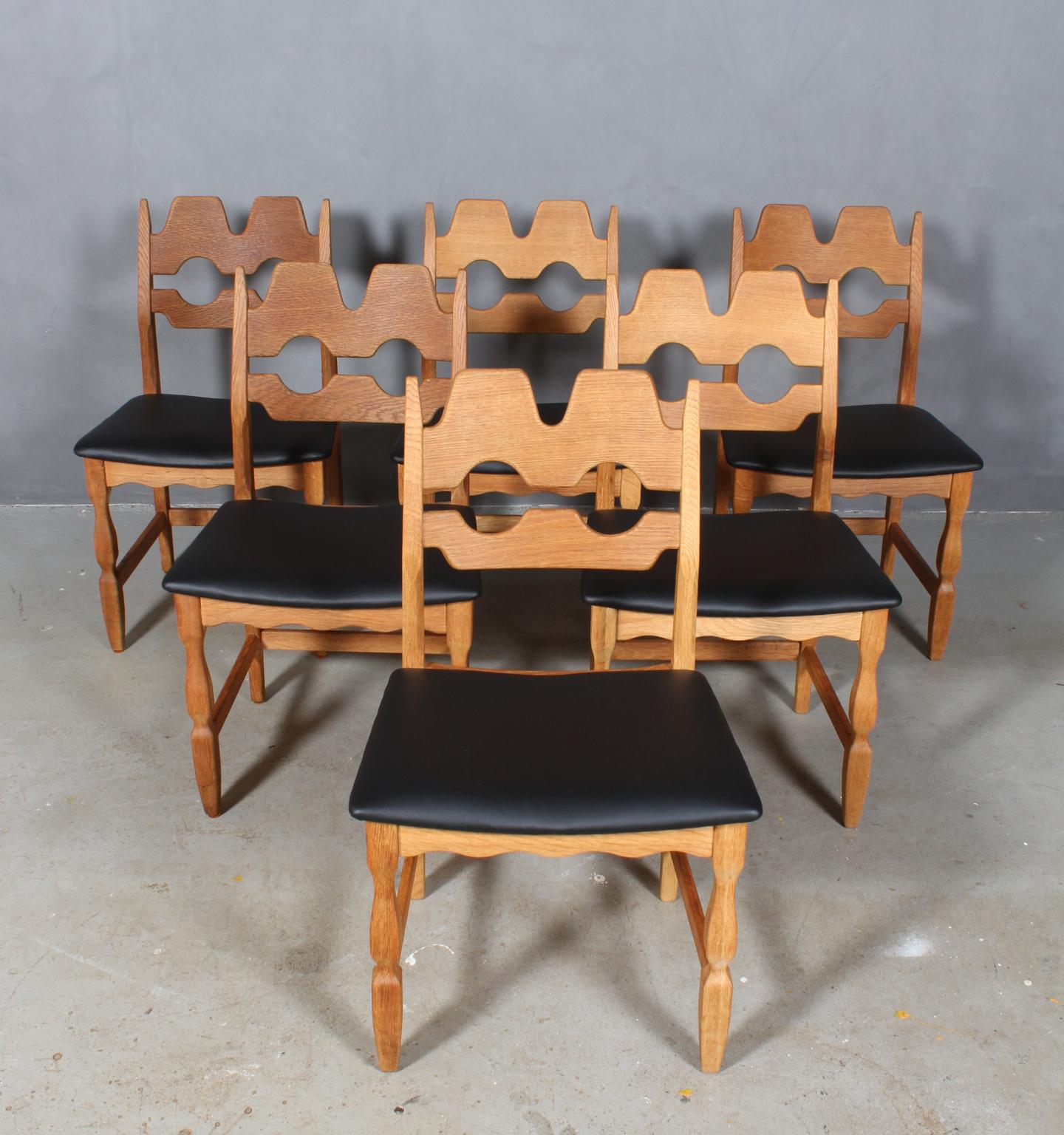 Set of six striking dining chairs by Henning Kjærnulf, made of oak and new upholstered with black semi aniline leather. 

Refreshing design with bold Baroque coming together nicely with Midcentury modernism.

Model: Razorblade

Made by EG møbler in