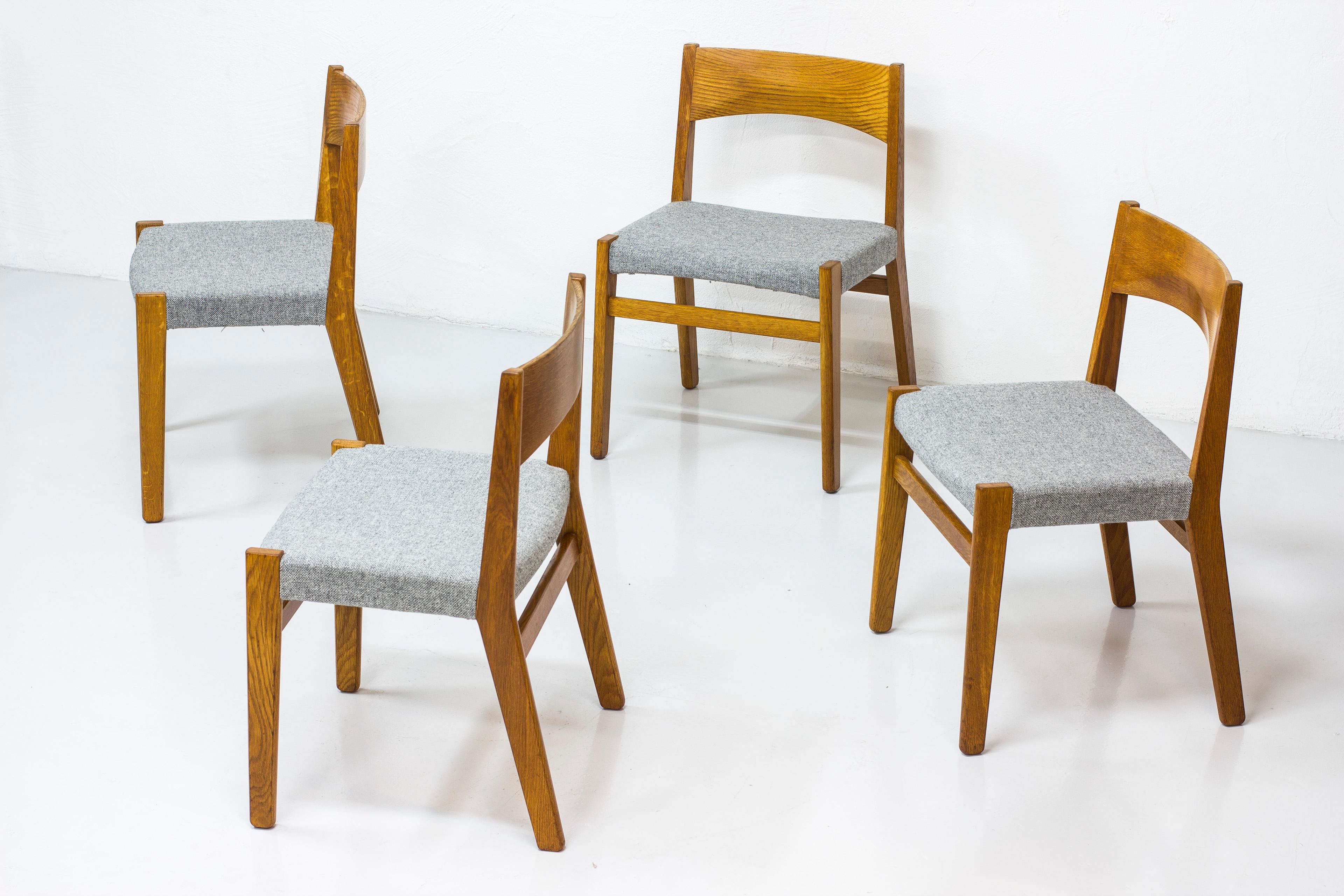 Set of four dining chairs designed by John Vedel Rieper. Produced in Denmark by Erhard Rasmussen. First presented at the Copenhagen Cabinetmakers’ Guild exhibition in 1957. Made from solid oak with new 