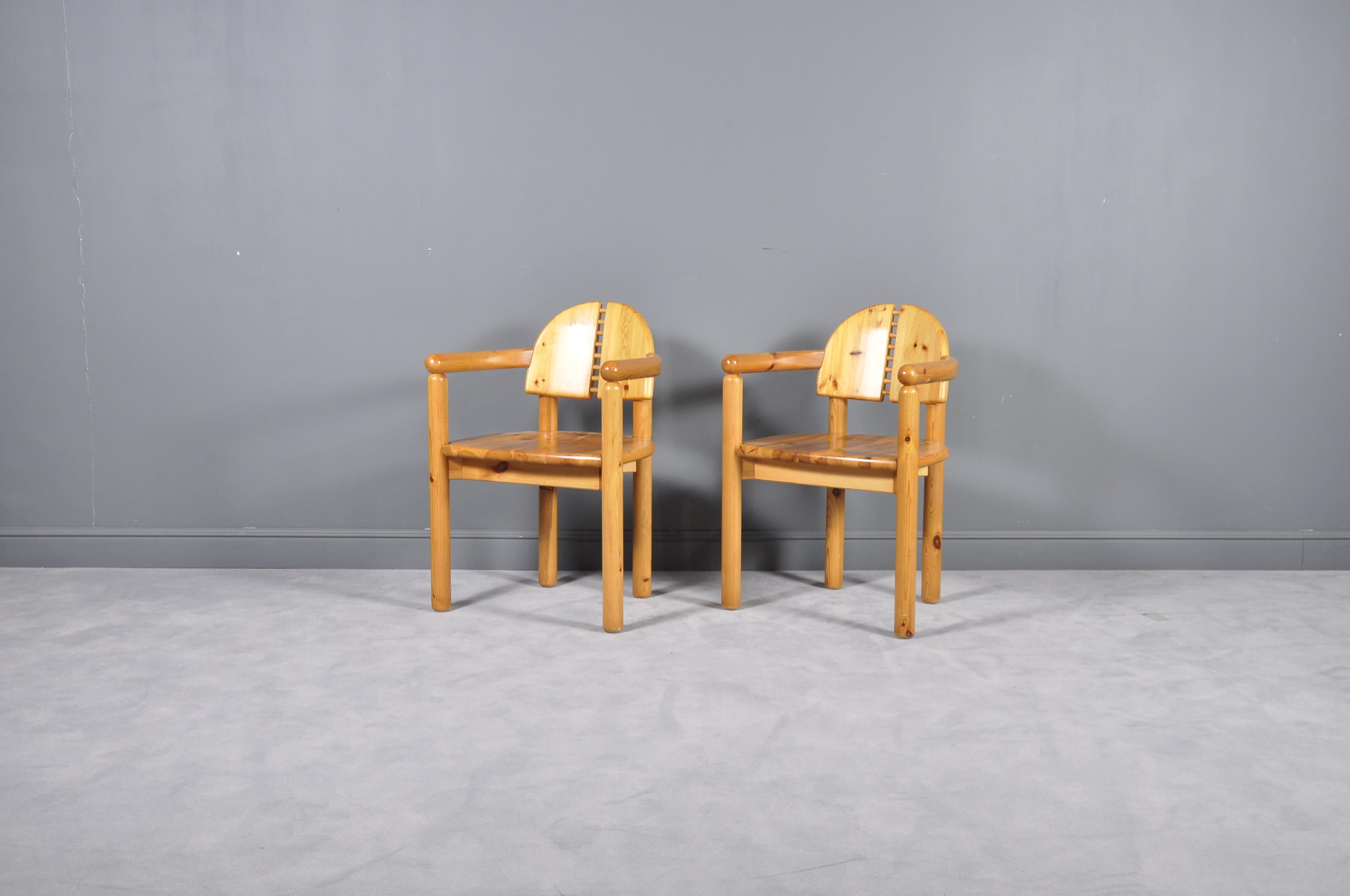Wonderful set of two very sculptural dining room chairs in pinewood by Swedish designer Rainer Daumiller, manufactured by Hirtshalls Sawmills. Notice the beautifully carved organic lines of the seats and the general natural feel of the grained