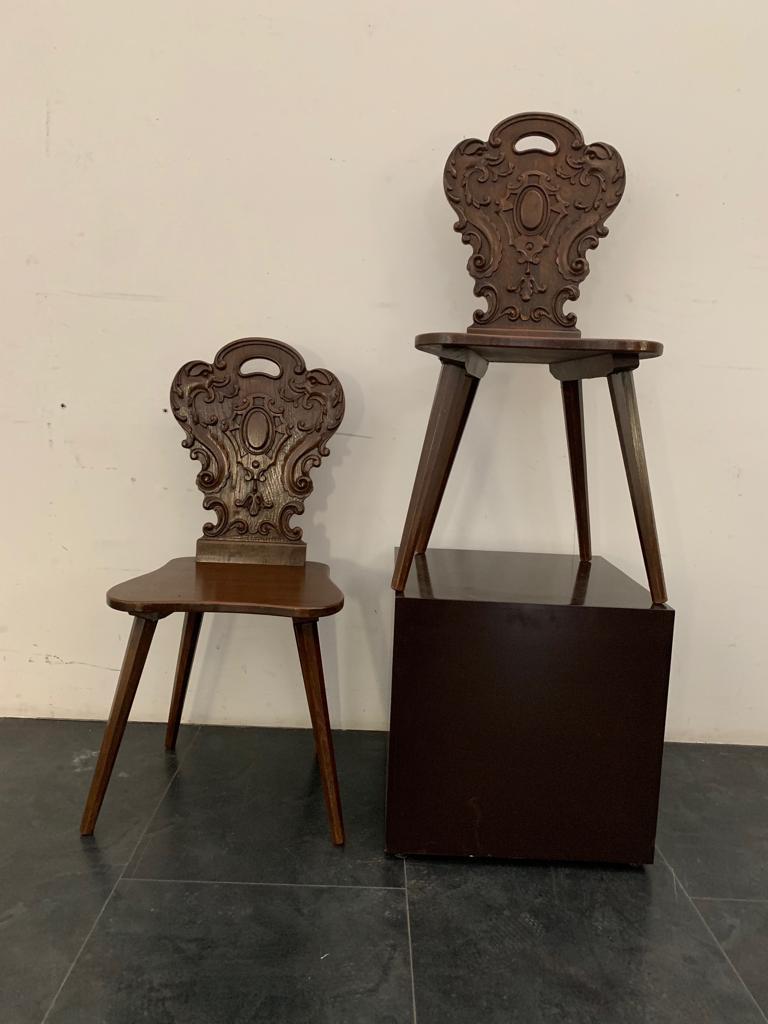Chairs with ace of cups backrest carved with nice marine grotesques. Stiletto legs, on the bottom carry a label with the manufacturer's initials and the model number. Italy 1950.