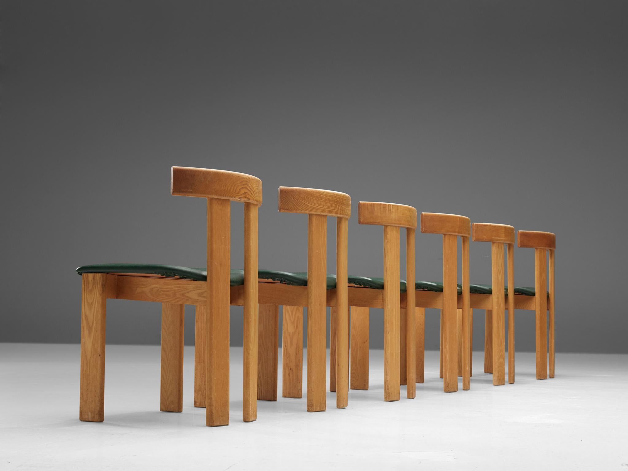 Dining chairs, ash and leatherette, France, 1960s.

Set of six sculptural chairs that feature wonderful backrests, consisting of two vertical slats distanced from each other. The slats are connected at the top with a curved slat, which gives this