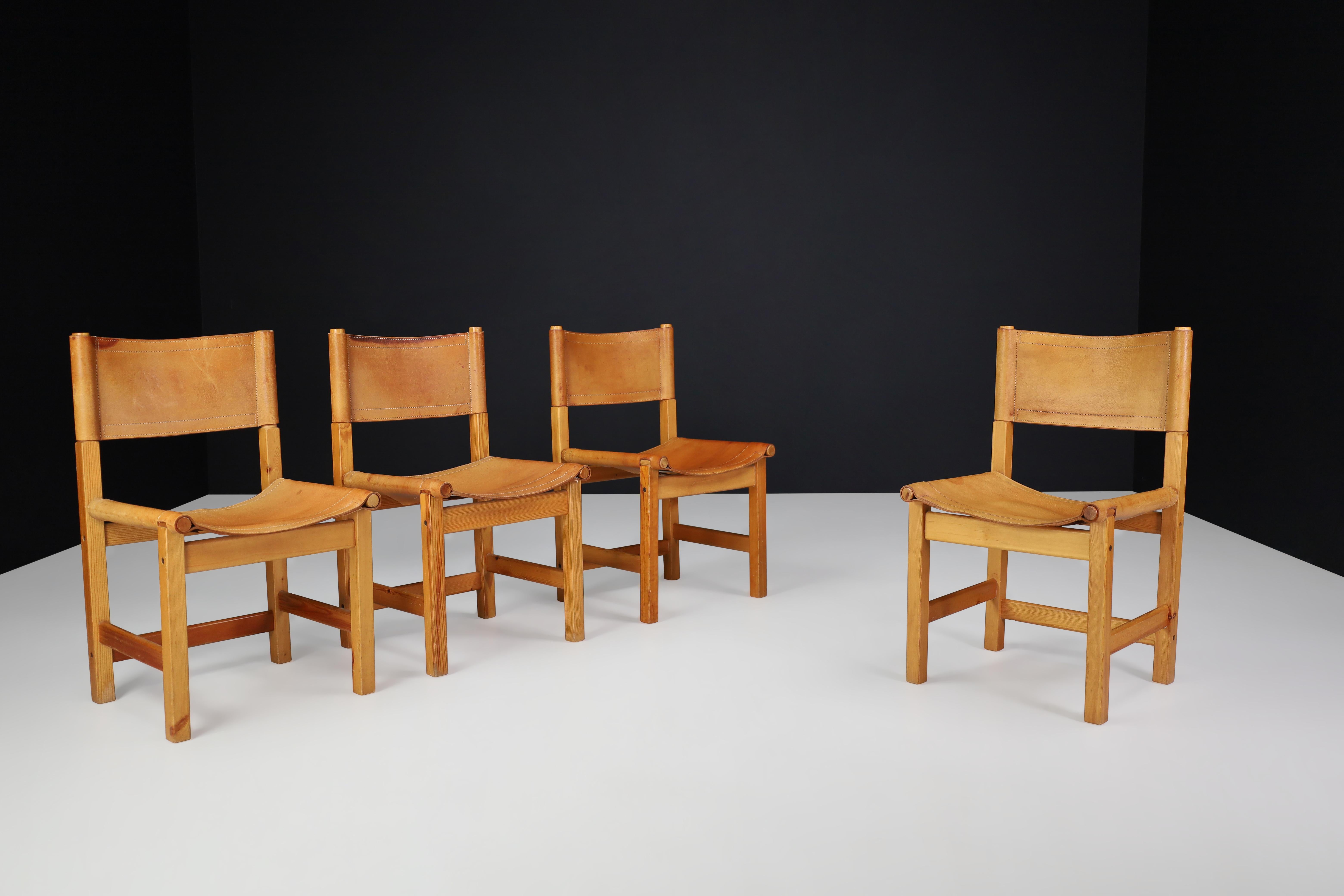 Dining Chairs in Pine and Leather, Sweden 1970s

This set of four dining chairs is made of pine wood and cognac-colored leather and was manufactured in Sweden in the 1970s. The chairs have a simplistic design with straight lines and are very sturdy.