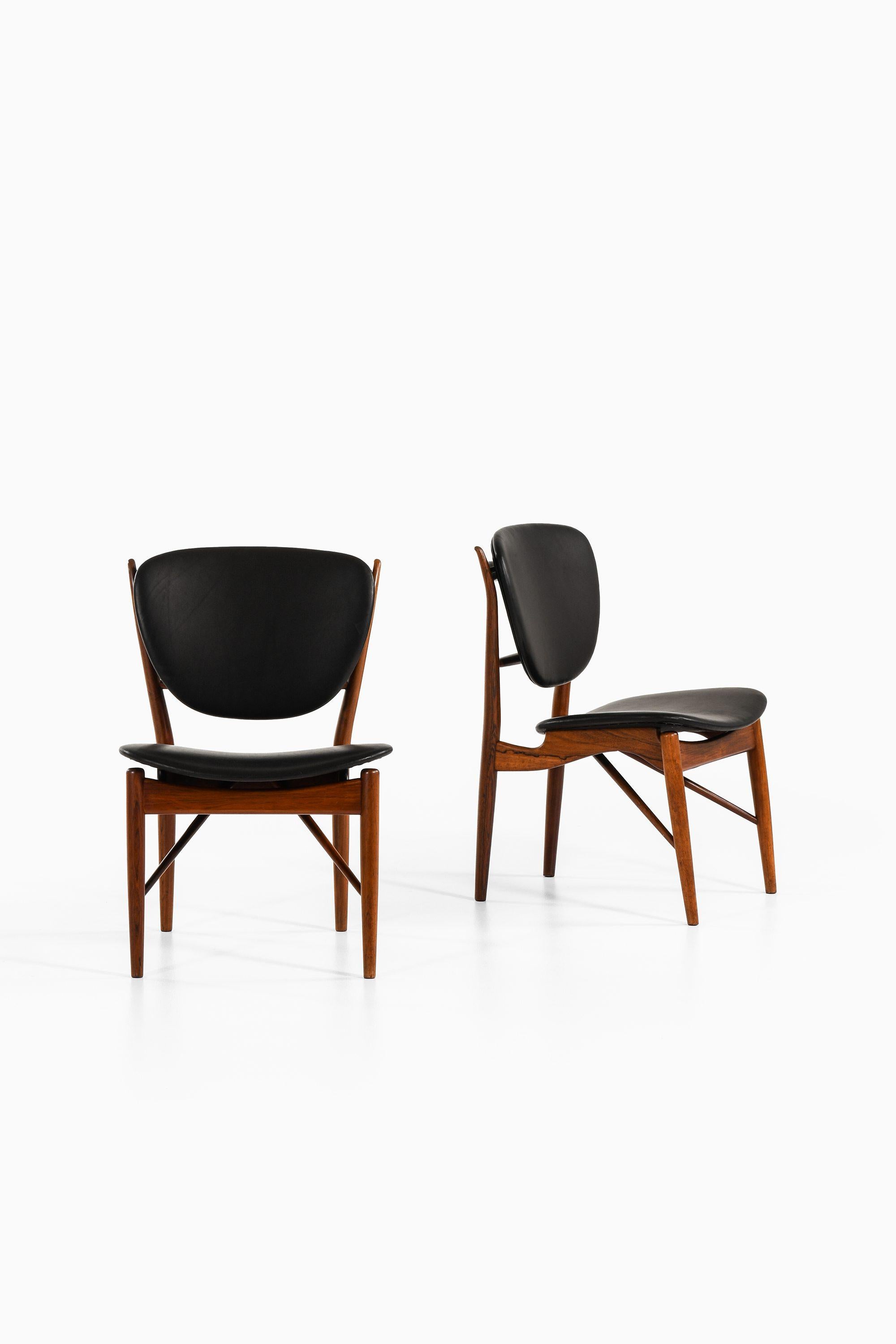 Scandinavian Modern Dining Chairs in Rosewood and Black Leather by Finn Juhl, 1951 For Sale