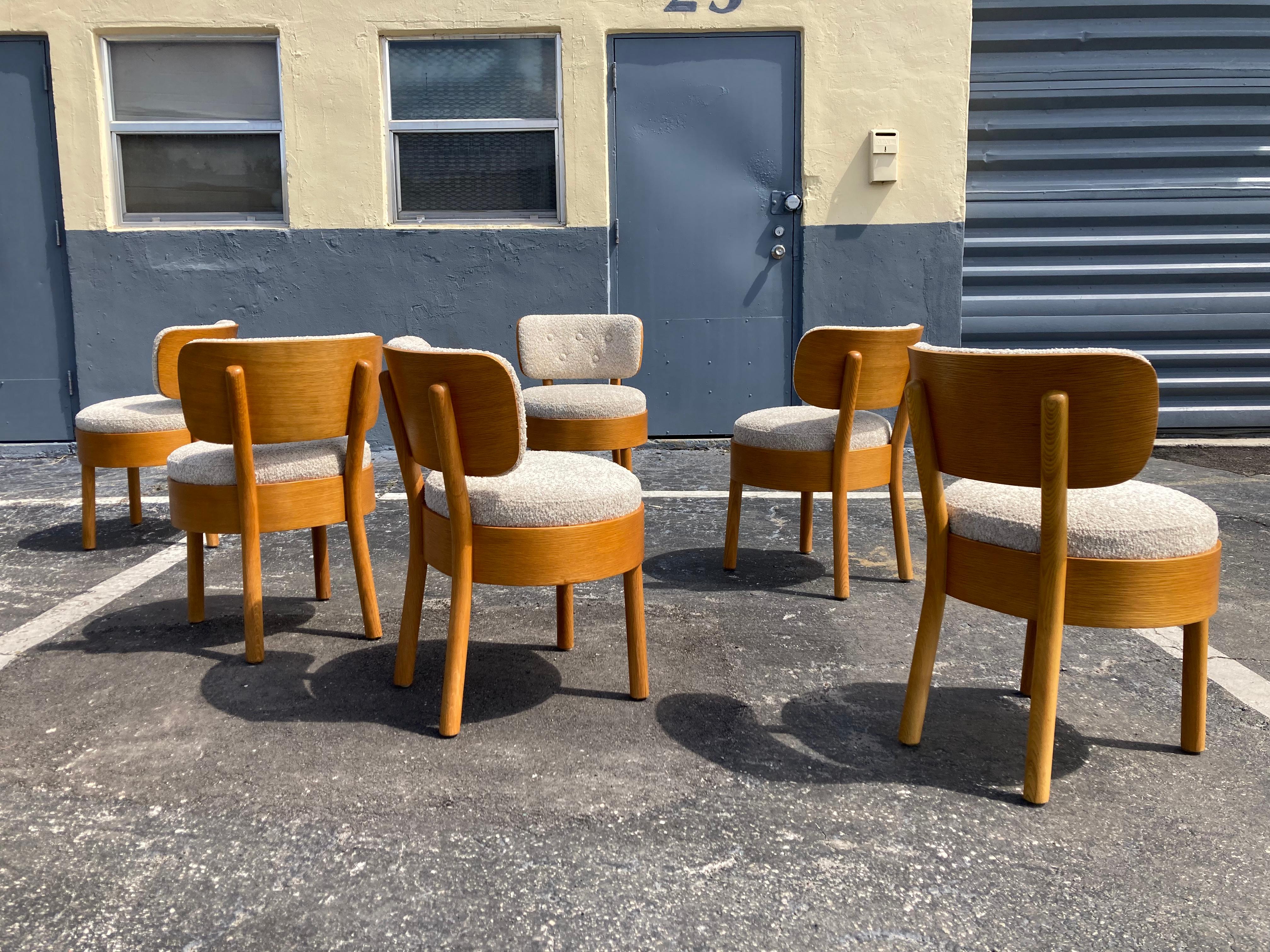 Great set of Six Dining Chairs in the style of Viggo Boesen, Bentwood oak seats and backs. The chairs have been reupholstered in sand colored boucle. In total twelve chairs available.