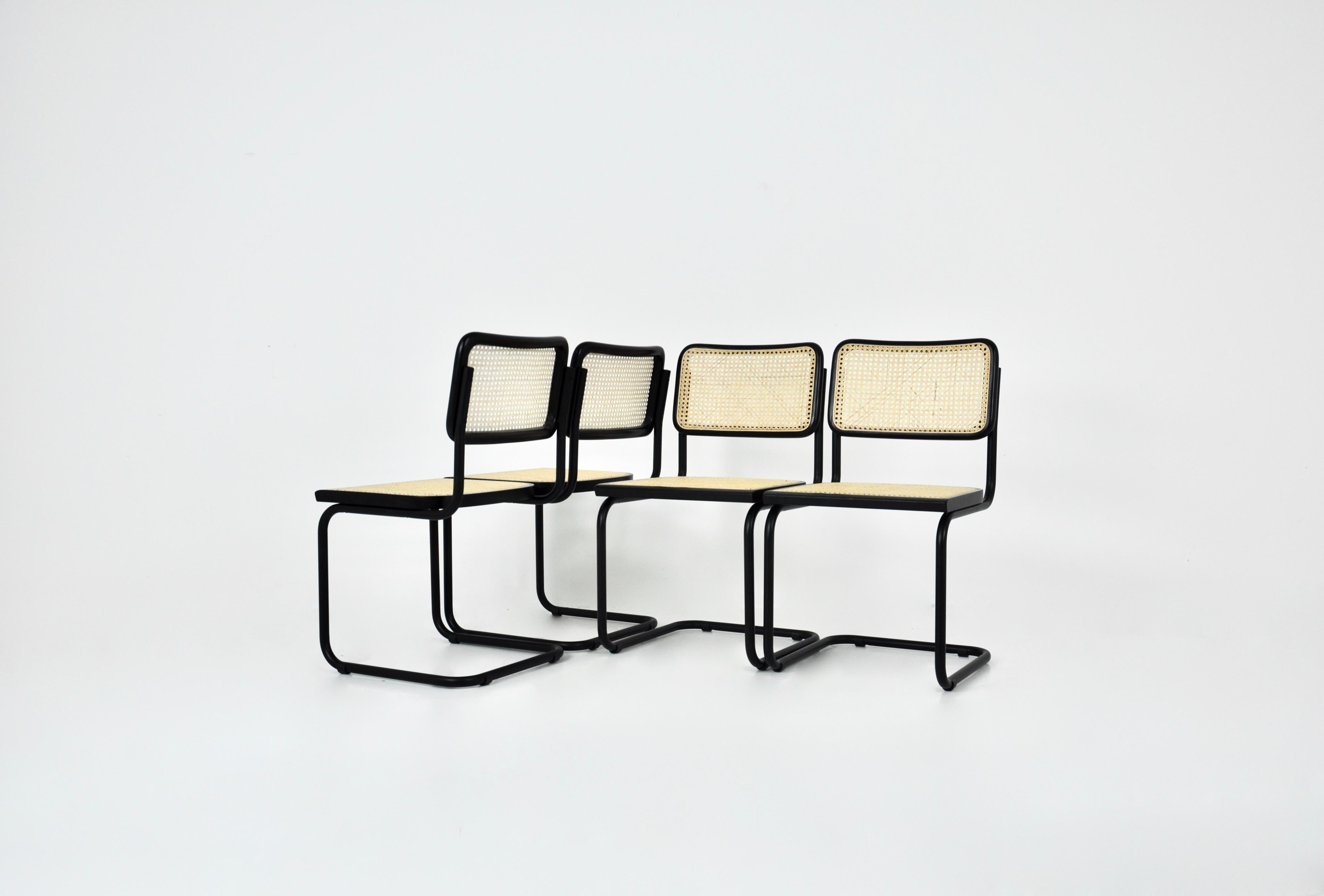Set of 4 black chairs in metal, wood and rattan. Dimensions: seat height: 46 cm. Wear due to time and age of the chairs.