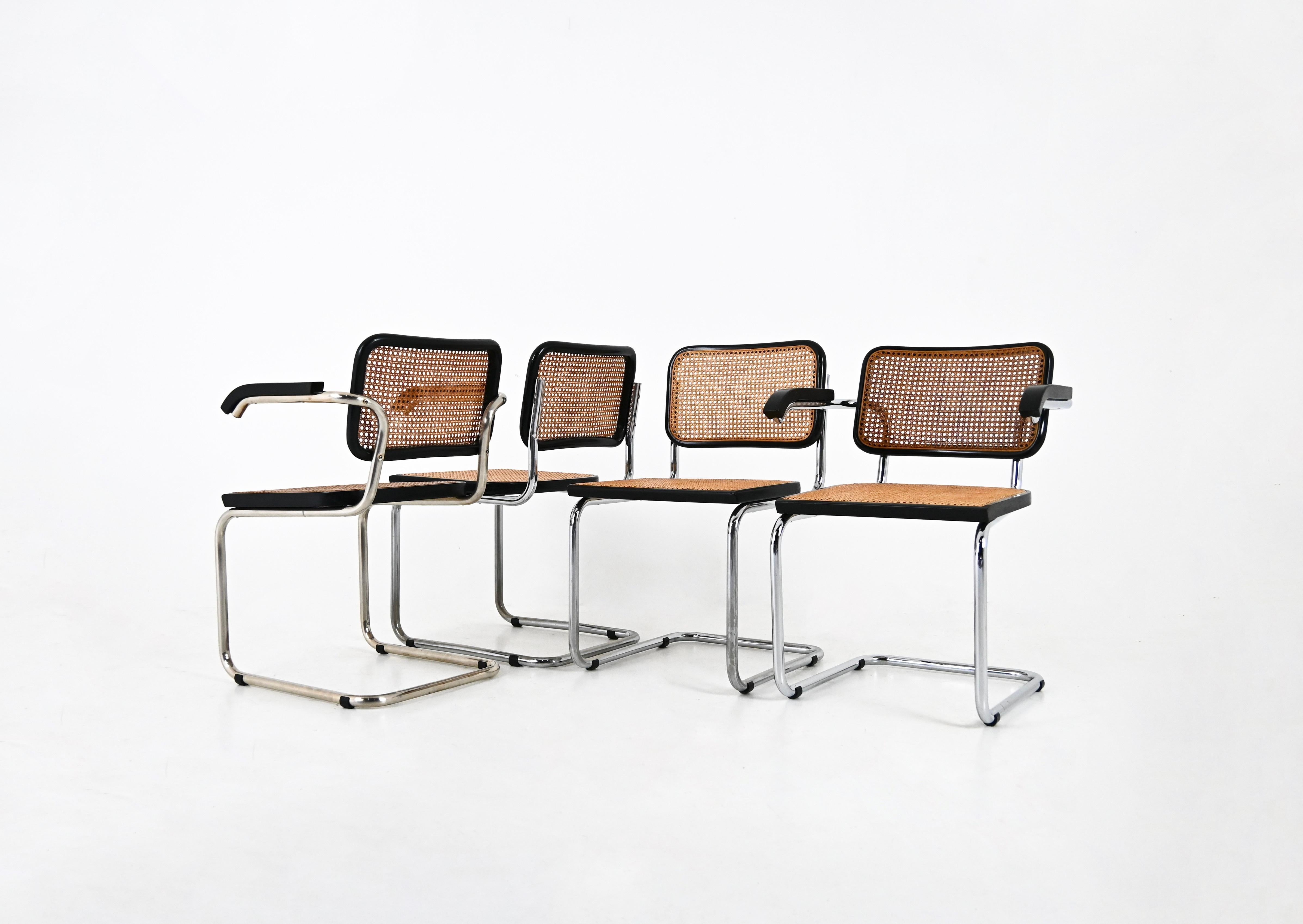 Set of 4 chairs in  black metal, wood and rattan. 
Dimensions: seat height: 46 cm. Width with armrests : 61 cm 
Wear due to time and age of the chairs. 
FOR SHIPPING, REQUEST US FOR RECEIVE THE BEST PRICE



