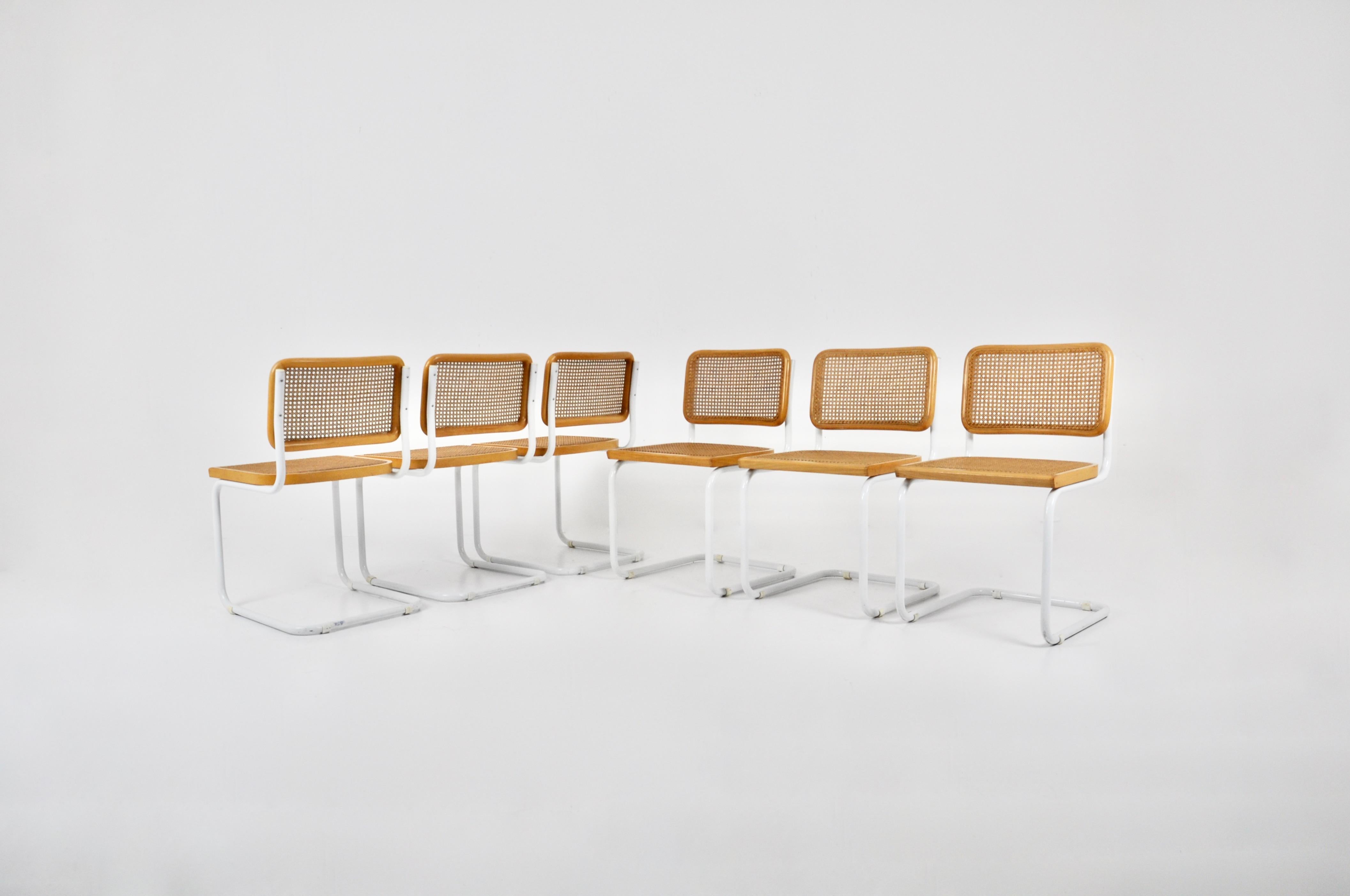 Set of 6 chairs in white metal, wood and cane. Wear due to time and age of the chairs. 
Measure: seat height: 45 cm.