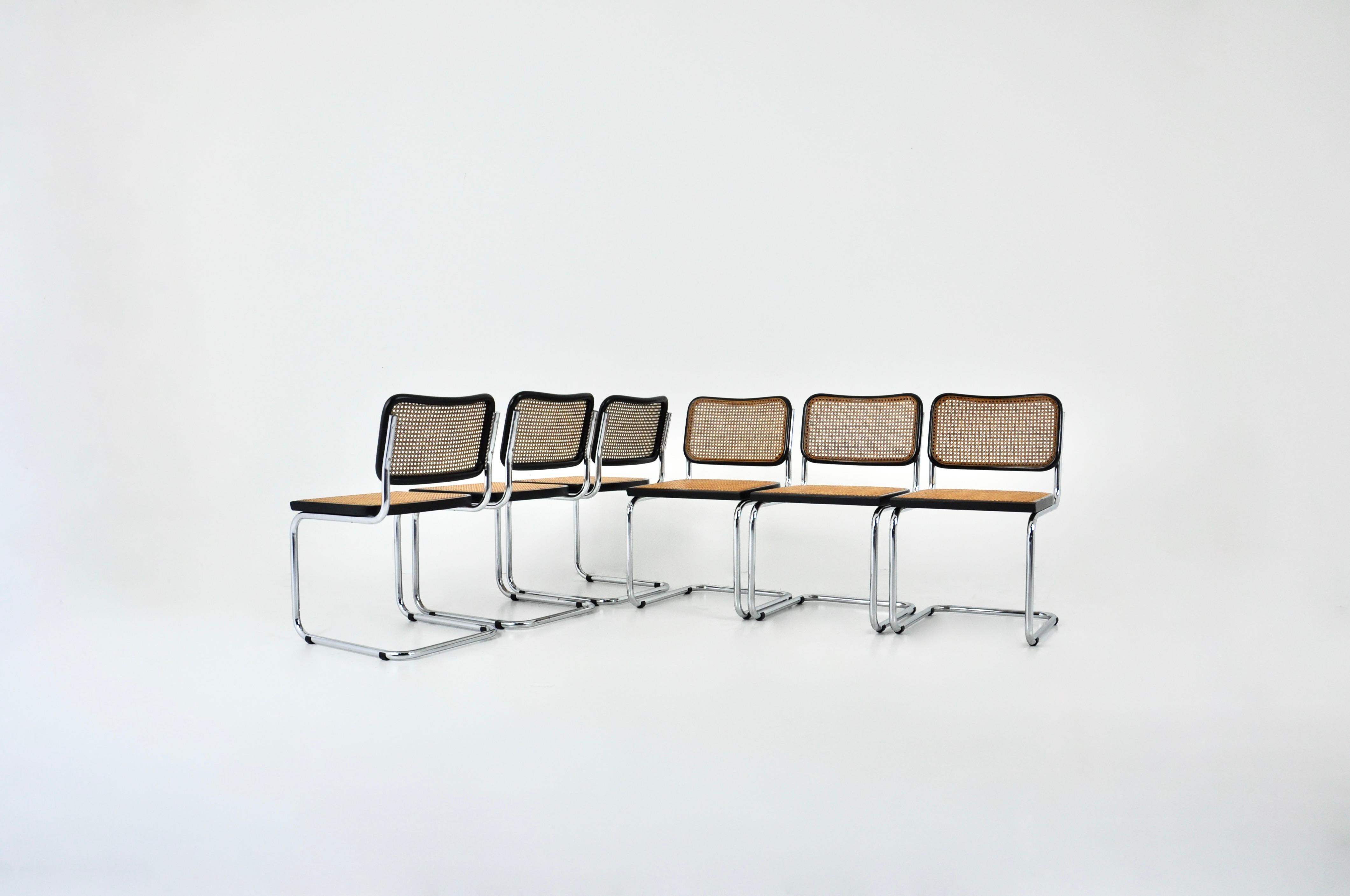 Set of 8 chairs in metal, wood and cane. Measure: seat height: 46cm. Wear due to time and age of the chairs.