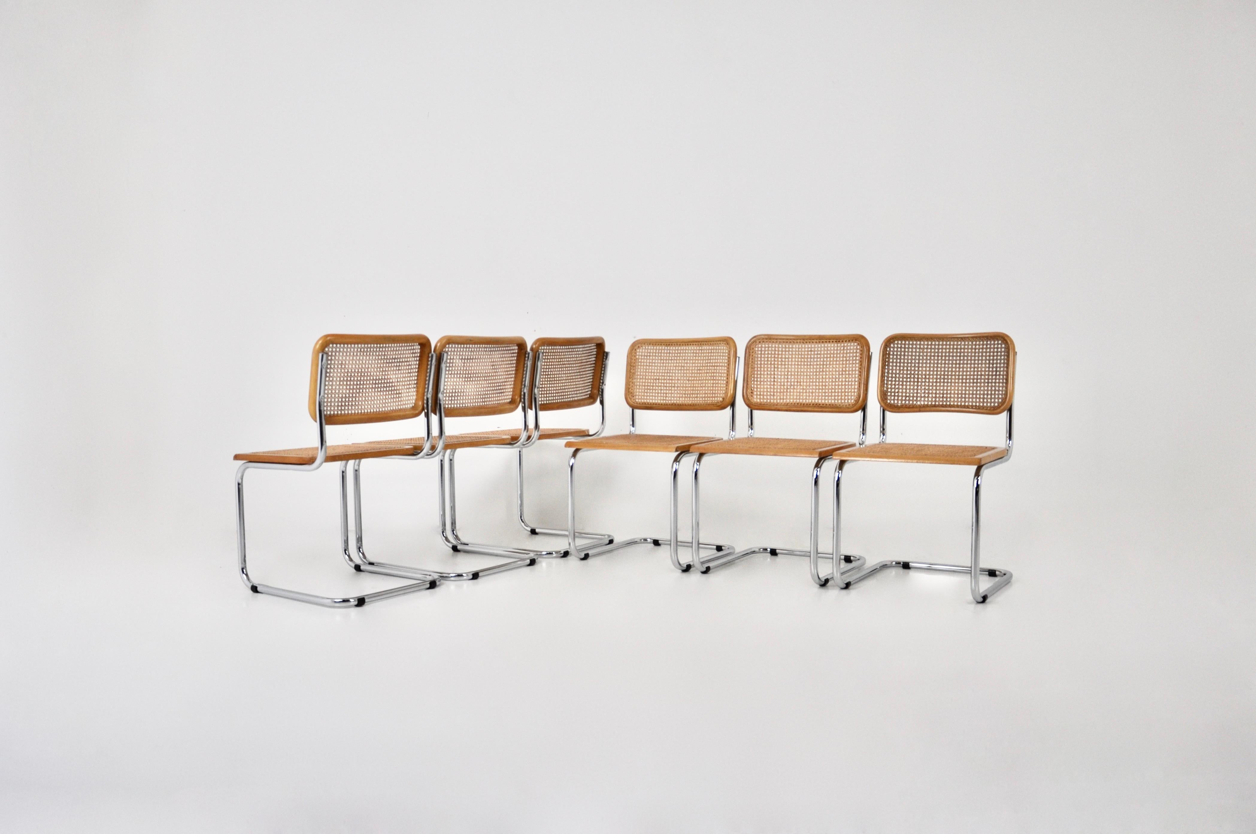 Set of 6 chairs in metal, wood and rattan. Dimensions: seat height: 45 cm. Wear due to time and age of the chairs. Sold by 6, the set cannot be divided.