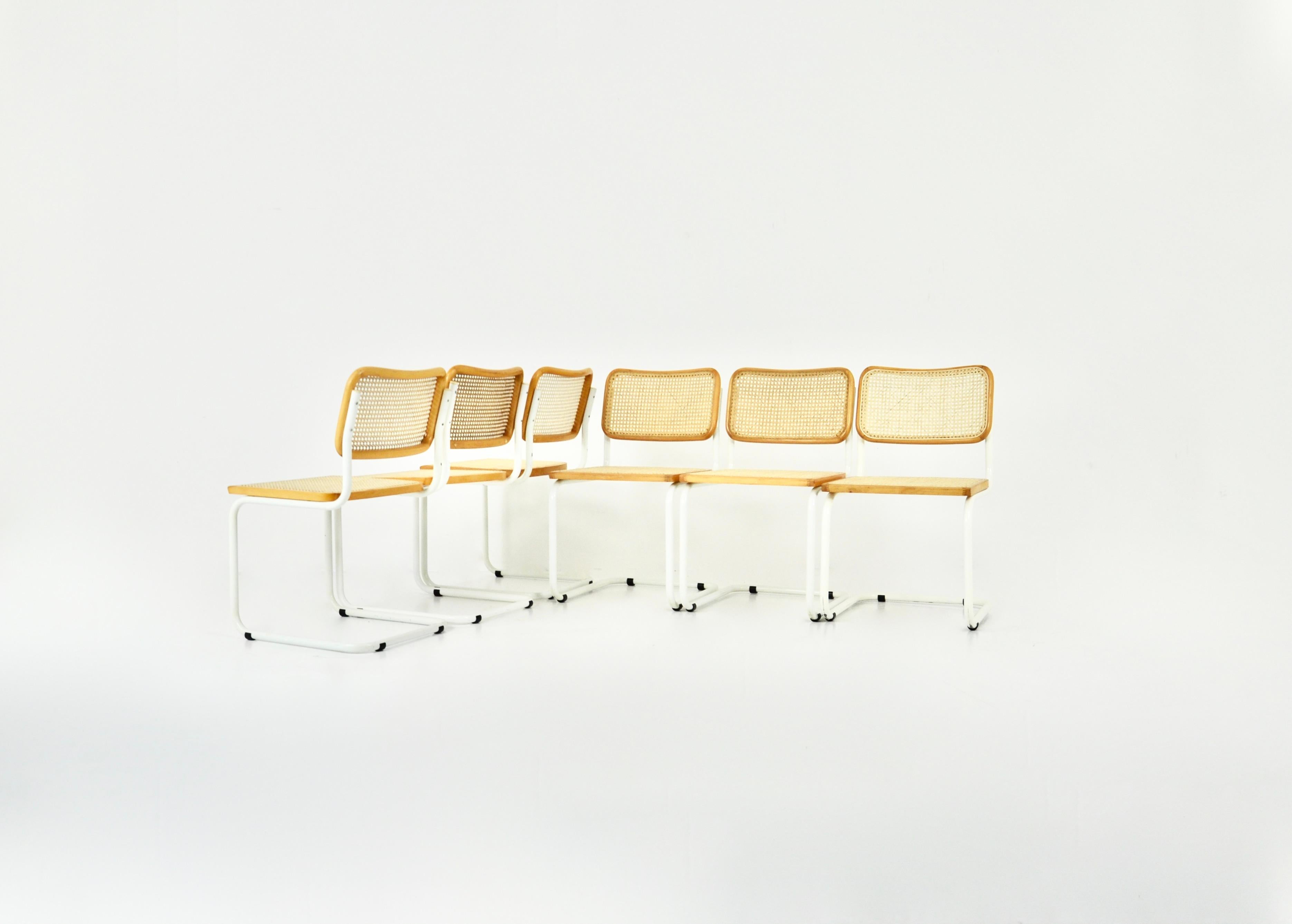 Set of 6 chairs in white metal, wood and cane. Wear due to time and age of the chairs. 
Dimensions: seat height: 45 cm.
Good condition
Wear due to the age of the chairs.
