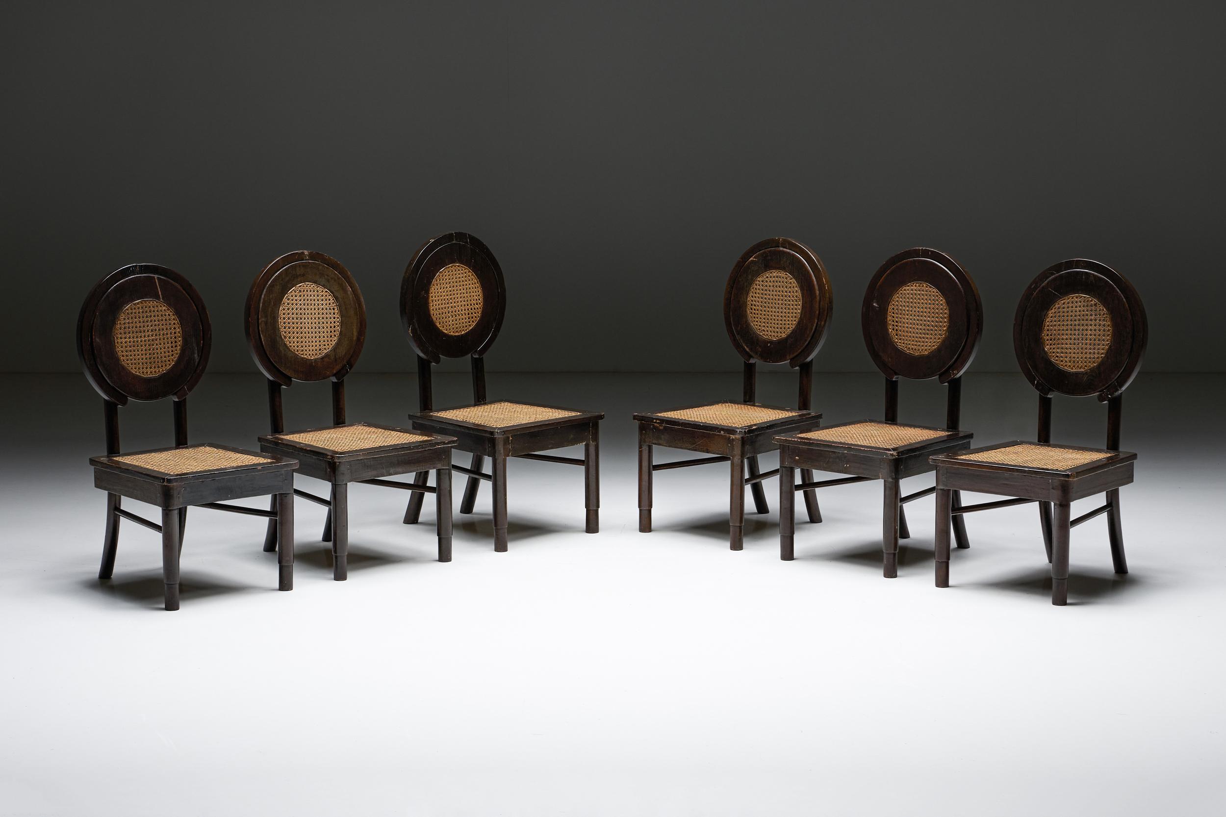 Dining Chairs; Cane Circle Back; Wood; 20th Century; Mid-Century Modern; Sculptural; Cane Work; Rustic; Artisan; Organic Furniture; Europe; Sculptural Chairs; 

Dining chairs with cane circle back and cane seating. Sculptural rustic chairs from