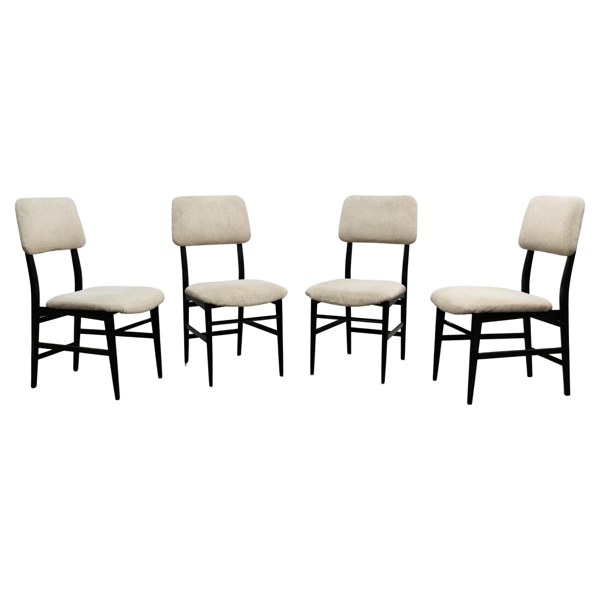 Set of 4 chairs with sinuous shapes designed by the designer Edmondo Palutari and produced by the Italian company Dassi in the 1950s. Each single chair was made of dark wood with seat and back in striped velvet in shades of cream and light