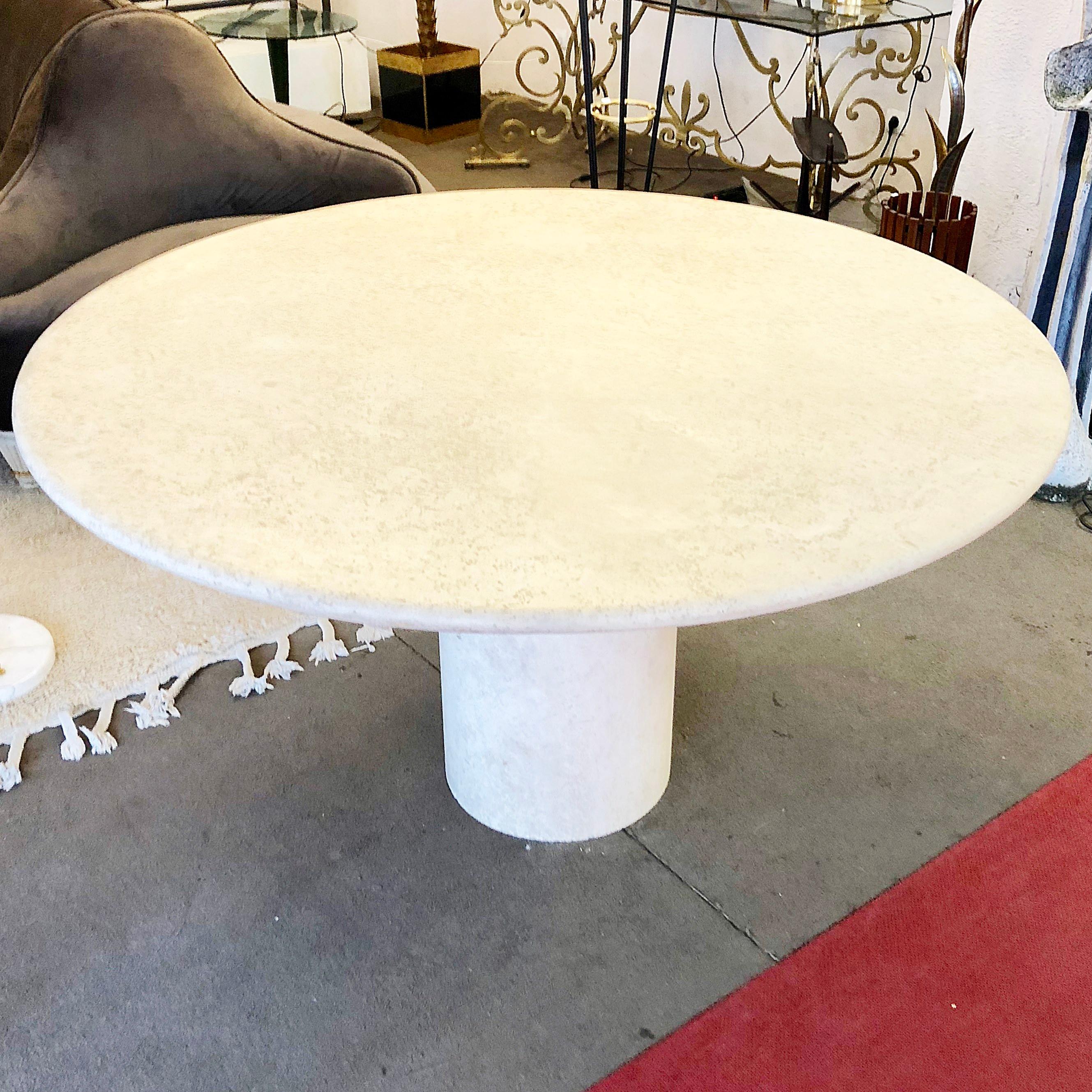 Dining pedestal table in travertine, circa 1970.