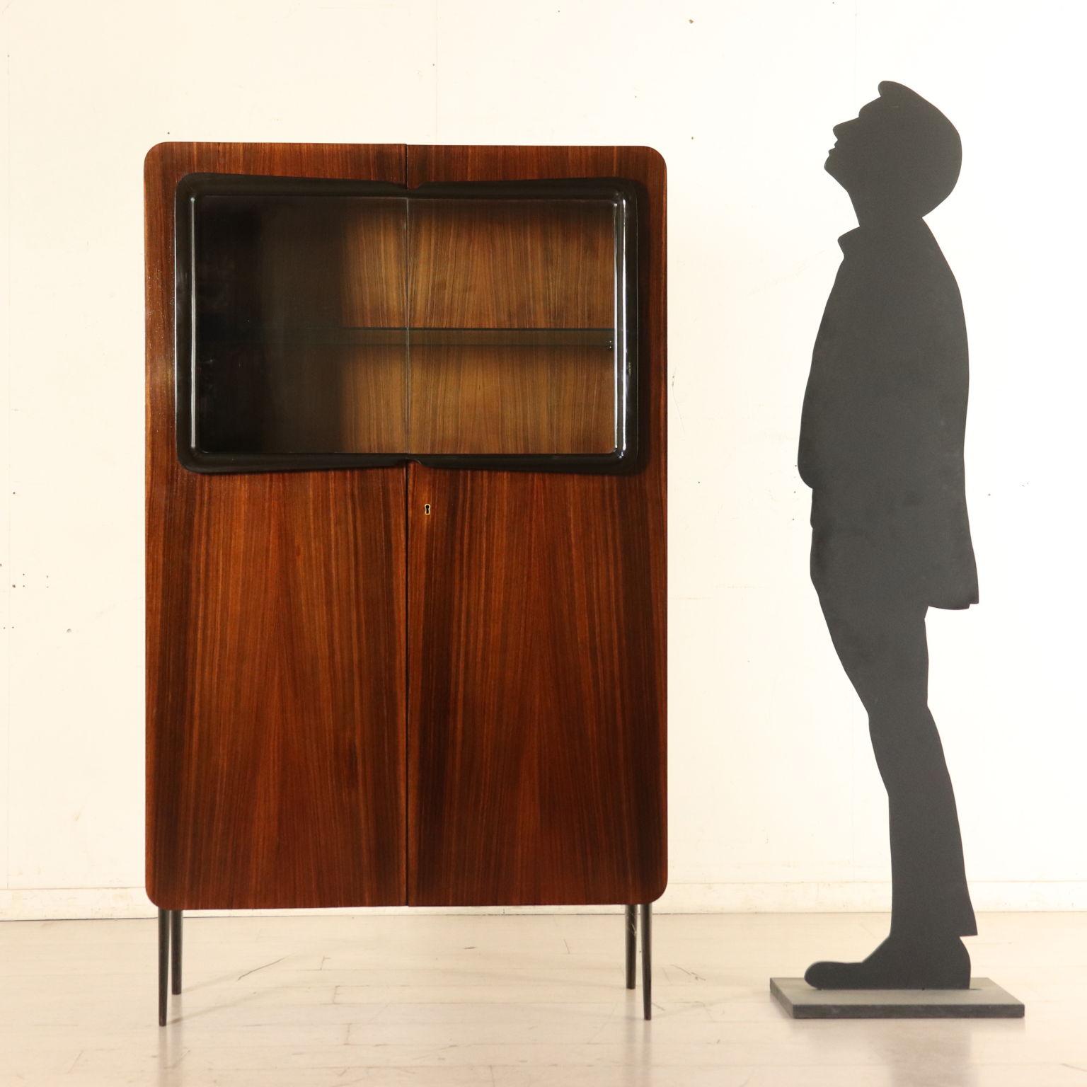 A dining room cabinet with hinged doors made of wood and glass. Designed by Ico Parisi (1916-1996) for Fratelli Rizzi. Inner shelf, wooden drawers and glass shelf. Mahogany veneer, solid wood with ebonized molding. It comes with Rizzi authentic.