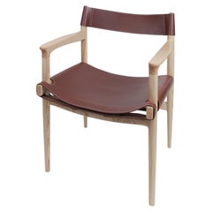 Dining room chair in ash with the sling leather seat