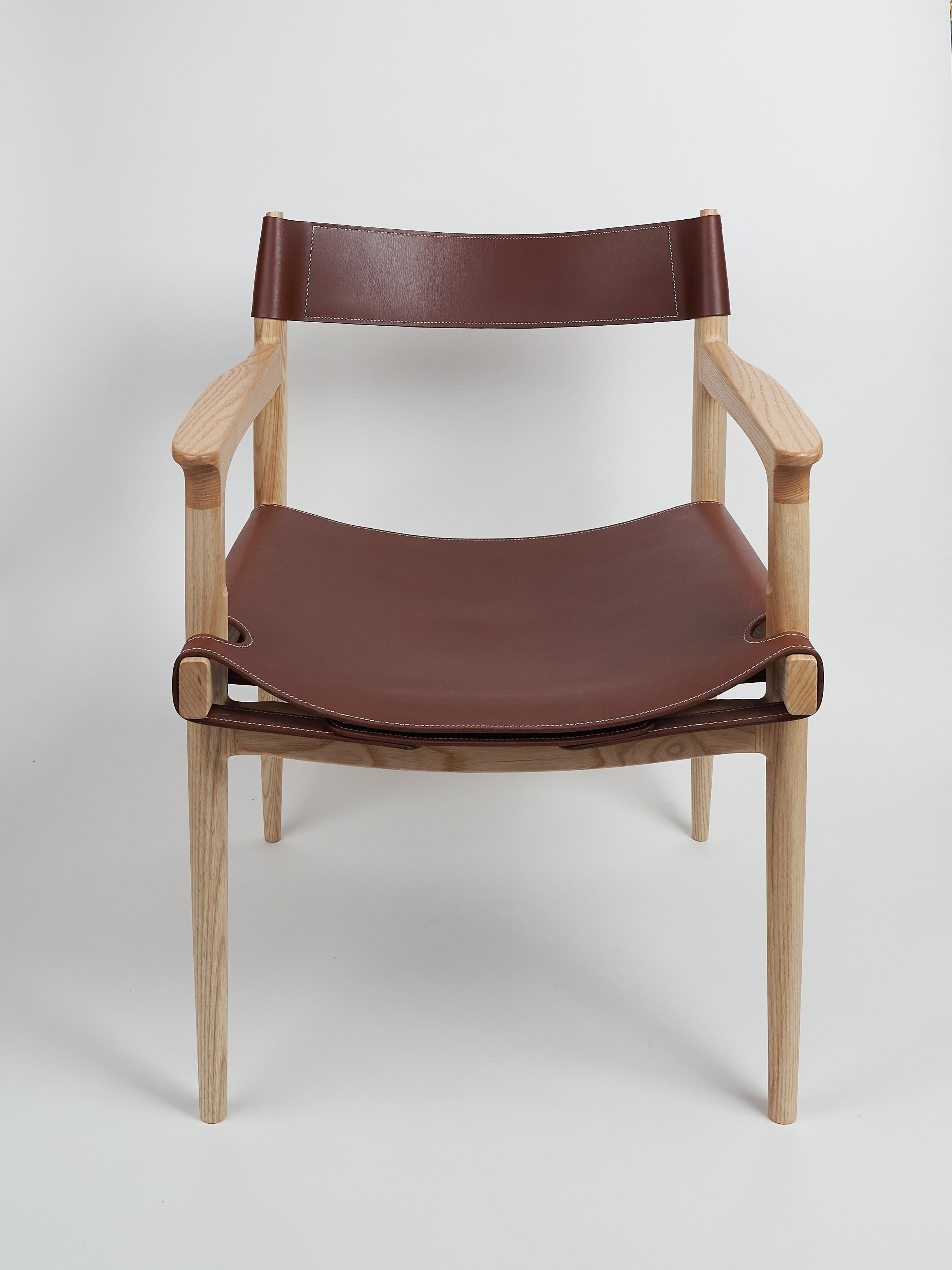 Scandinavian Modern Dining room chair in ash with the sling leather seat For Sale