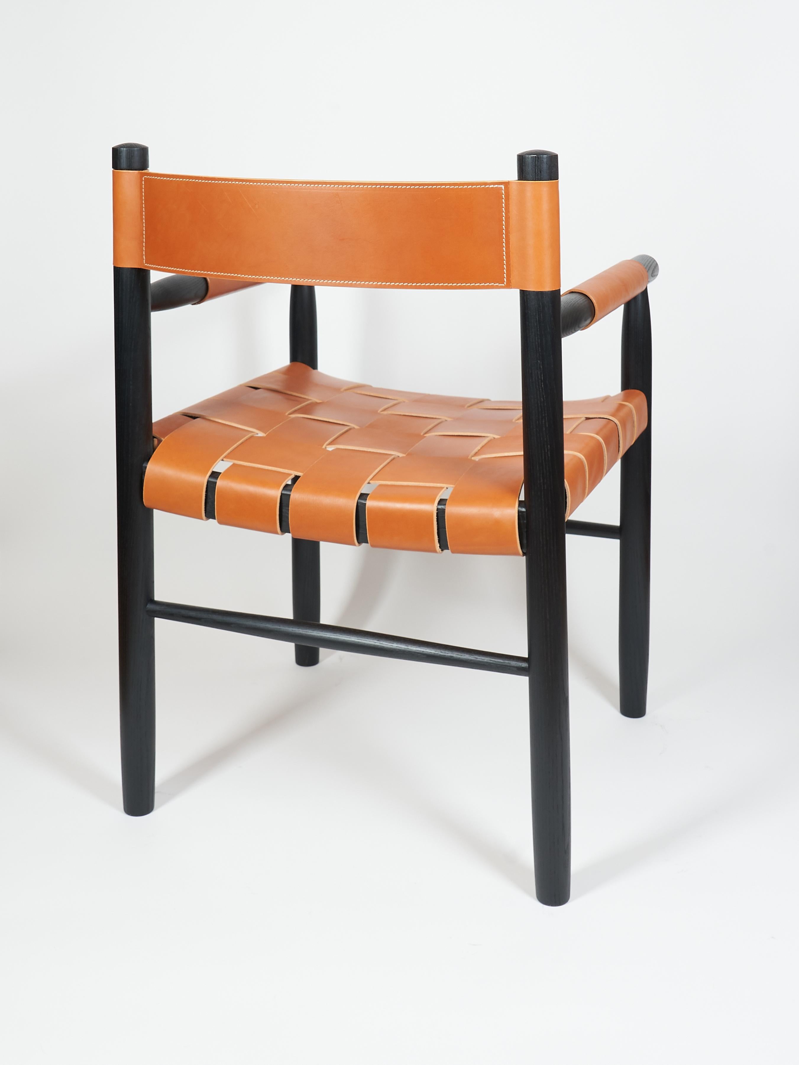 Dining room chair in ebonized ash with the woven leather seat and backrest In New Condition For Sale In Millburn, NJ