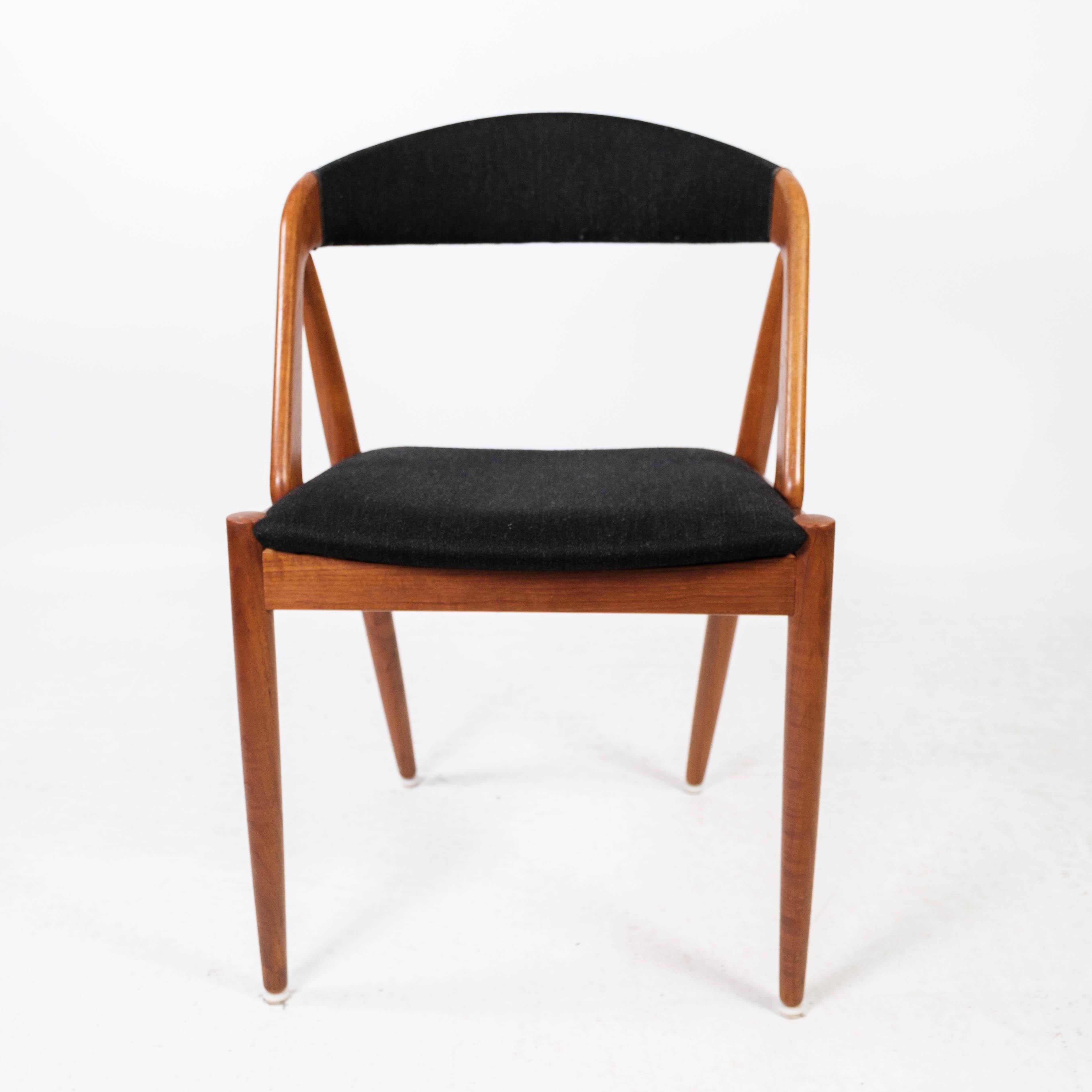 Dining room chair, model 31, designed by Kai Kristiansen in 1956 and manufactured by Schou Andersen in the 1960s. The chair is of teak and upholstered in black fabric.