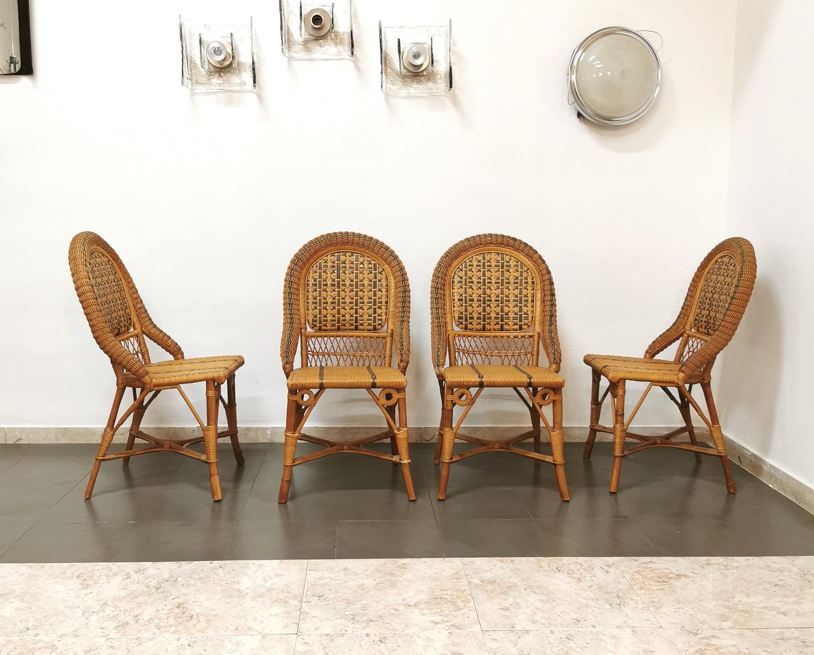 Set of 4 dining or living room chairs produced in Italy in the 70s by the Vivai del sud company. Every single chair has been made of bamboo and rattan, with the particularity of the green weaves on the seat and back with a rounded shape.