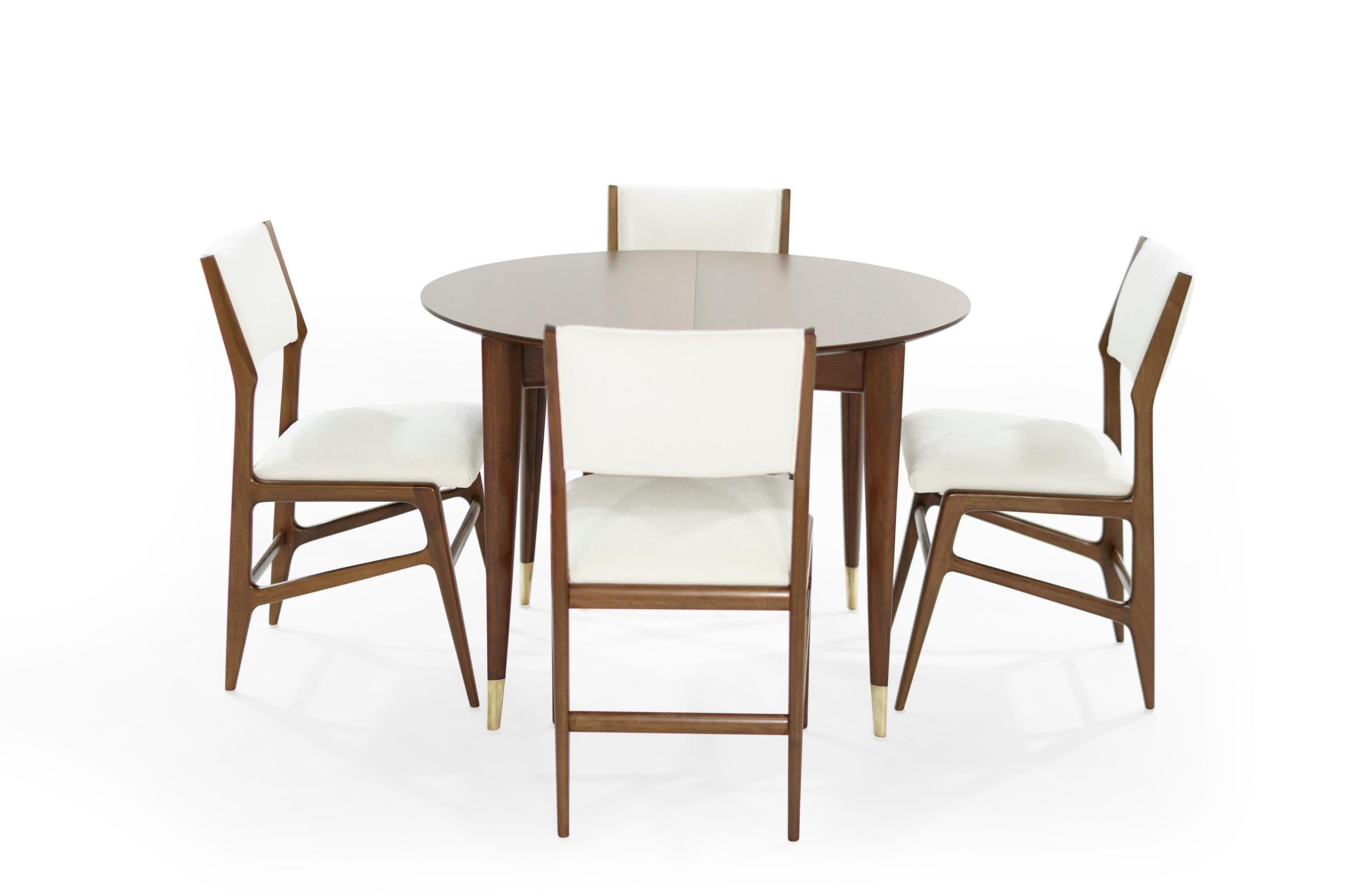Extremely rare dining room set, designed by the iconic Gio Ponti for M. Singer & Sons, circa 1950-1959. Original label attached underneath the table. Pre-restoration images included.

Walnut dining table features Gio Ponti's signature brass