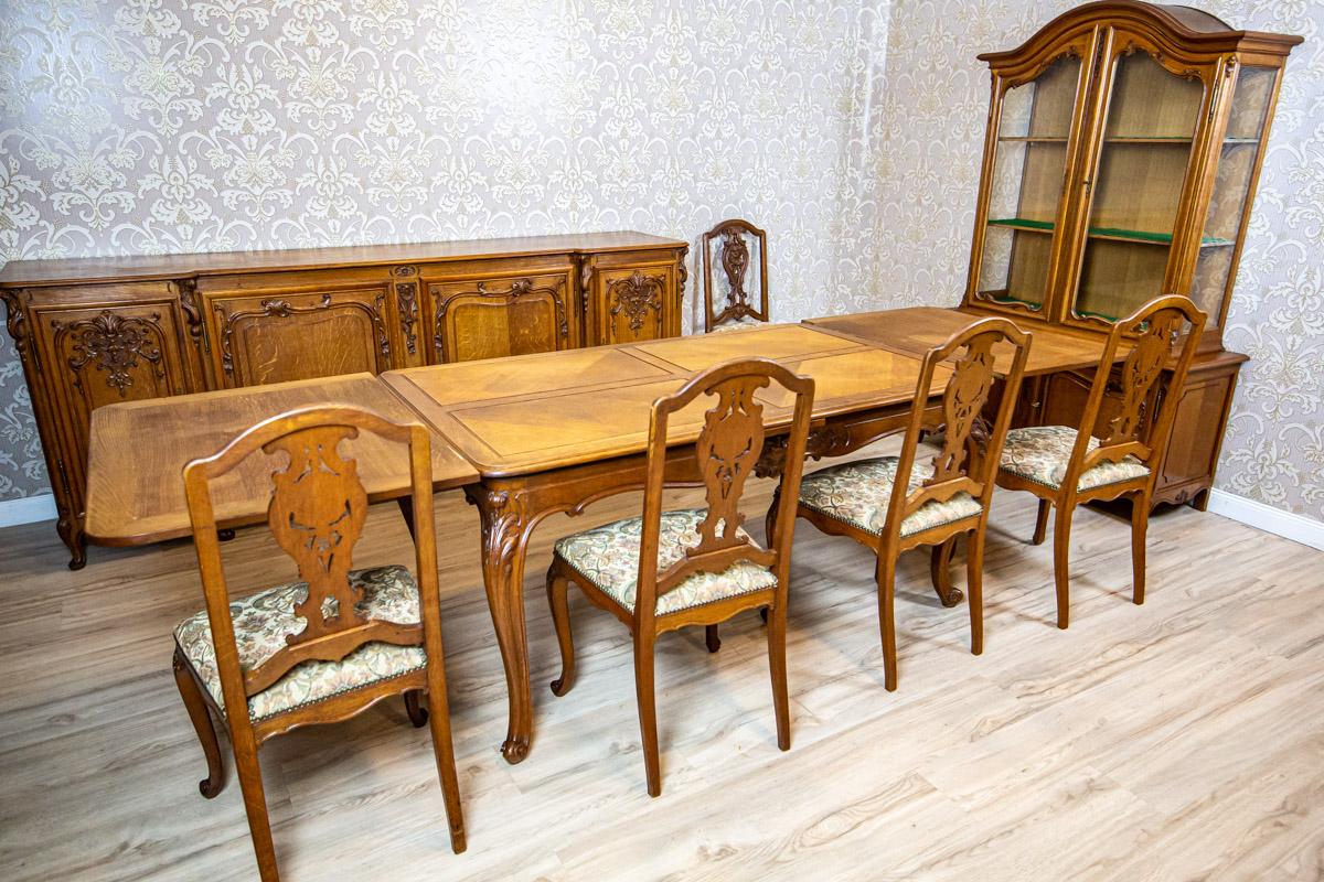 Ash Dining Room Set with Upholstered Chairs, circa 1920

We present you this dining room set composed of a table, 8 chairs, a sideboard, and a showcase.
The rectangular table with extra side parts is supported on cabriole legs.
The showcase is